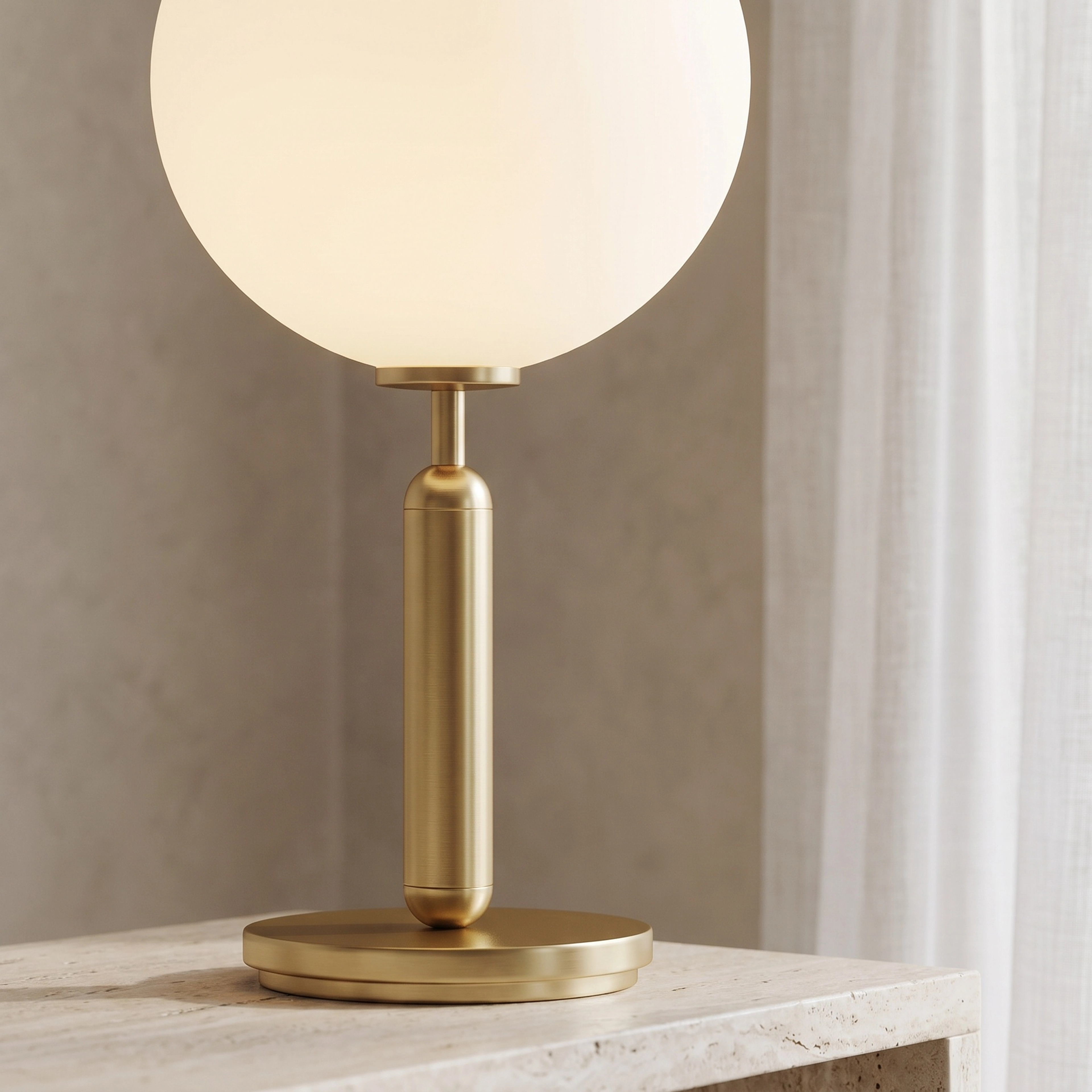 Angelica gold table lamp, white opal-glass globe on a brass stem, on a wood nightstand beside a bed
