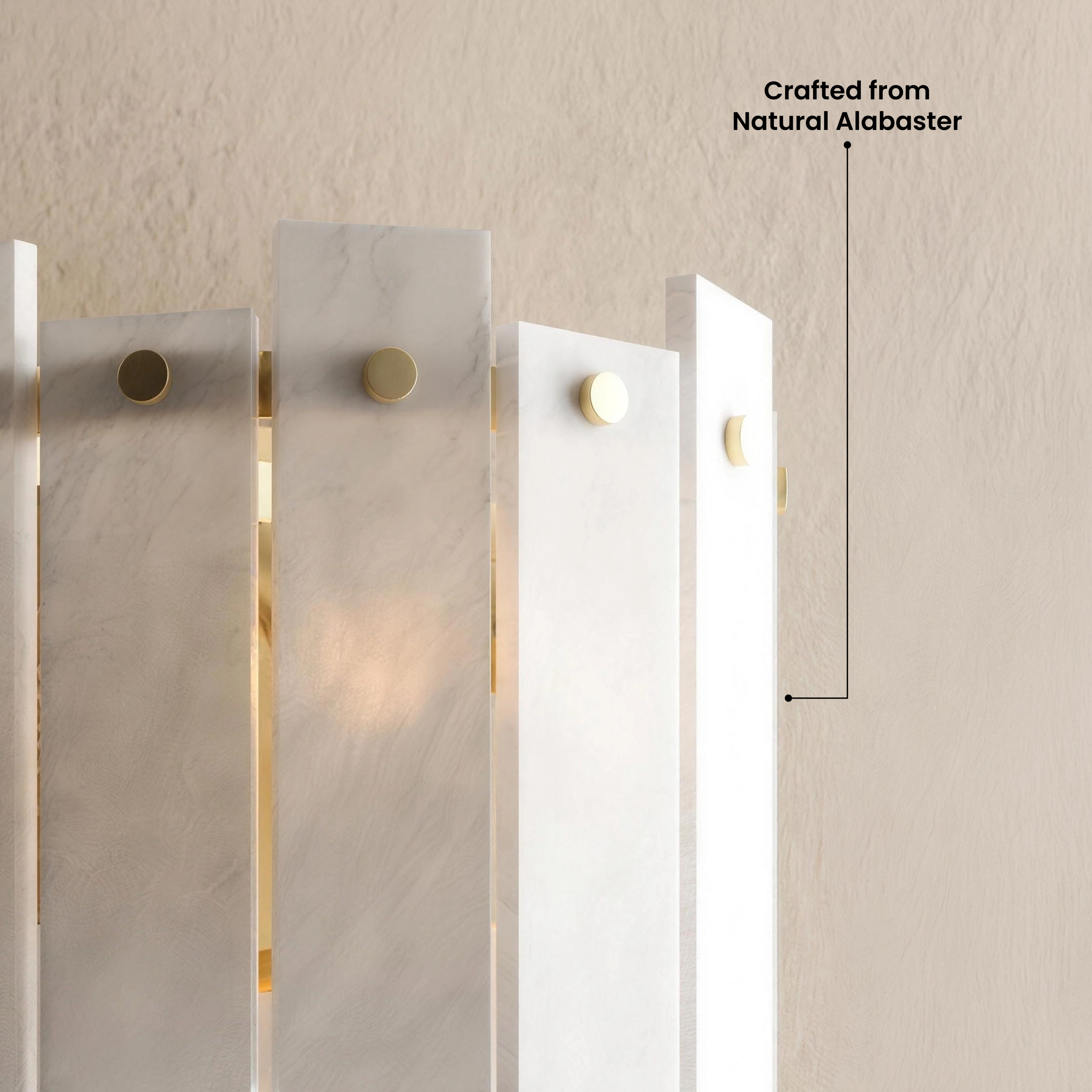 Velina Sconce gold wall light with layered alabaster panels above an armchair in a warm-toned room