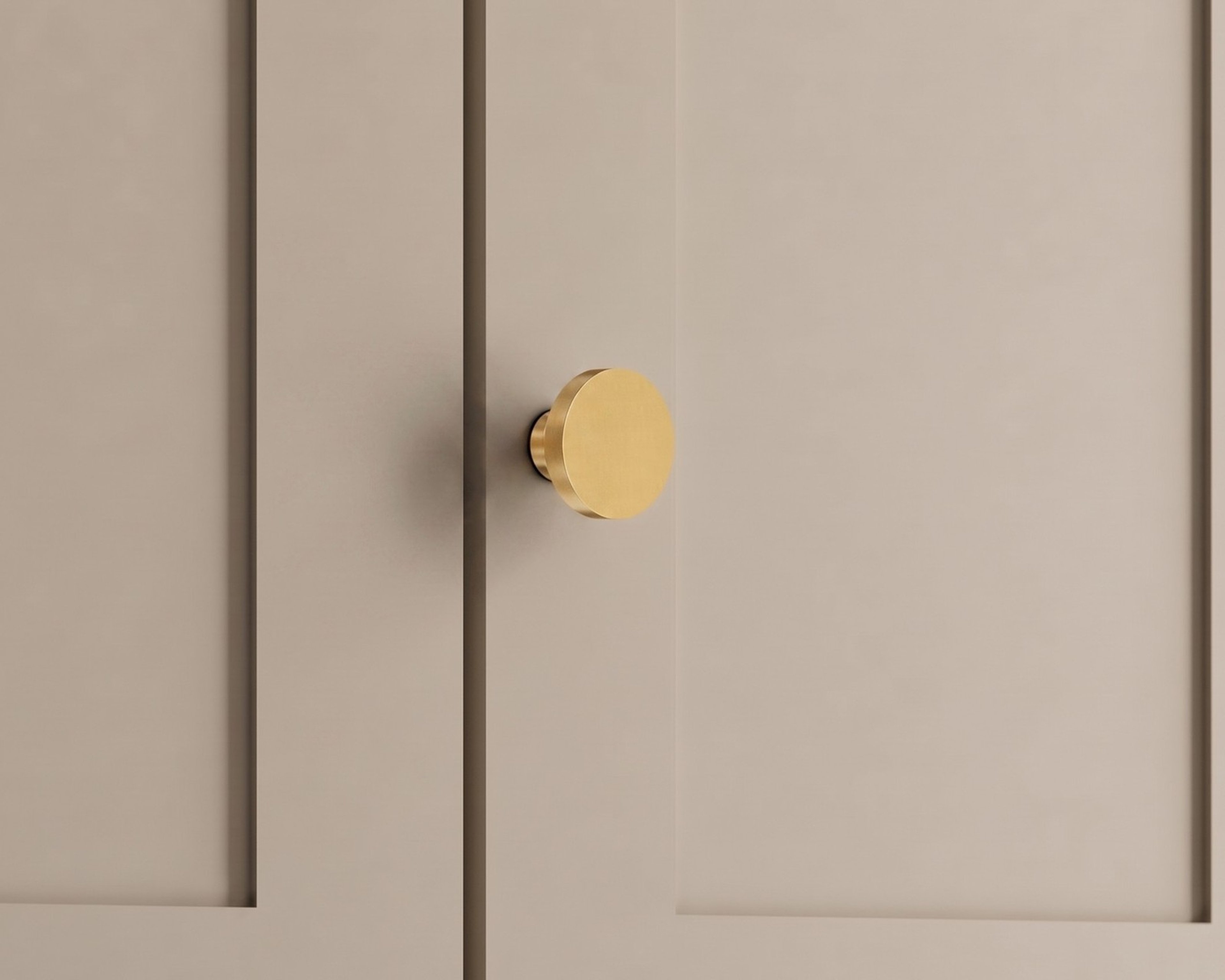 Balmuto brass cabinet knob on a beige cabinet