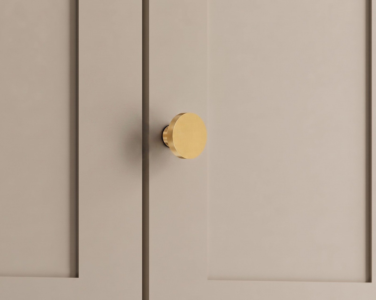 Balmuto brass cabinet knob on a beige cabinet