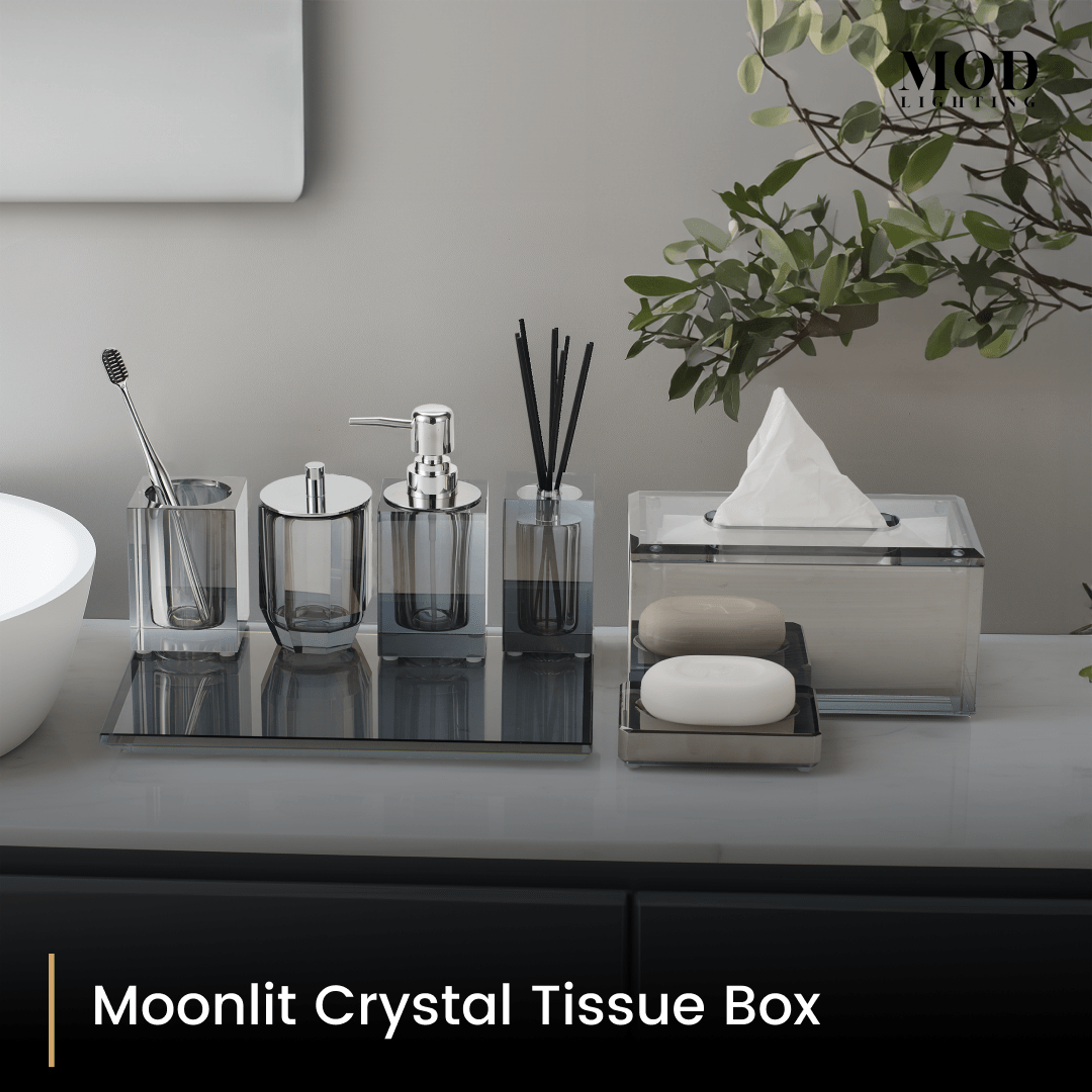 Moonlit Crystal Tissue Box with matching smoky crystal bath set on a grey vanity beside a round basin
