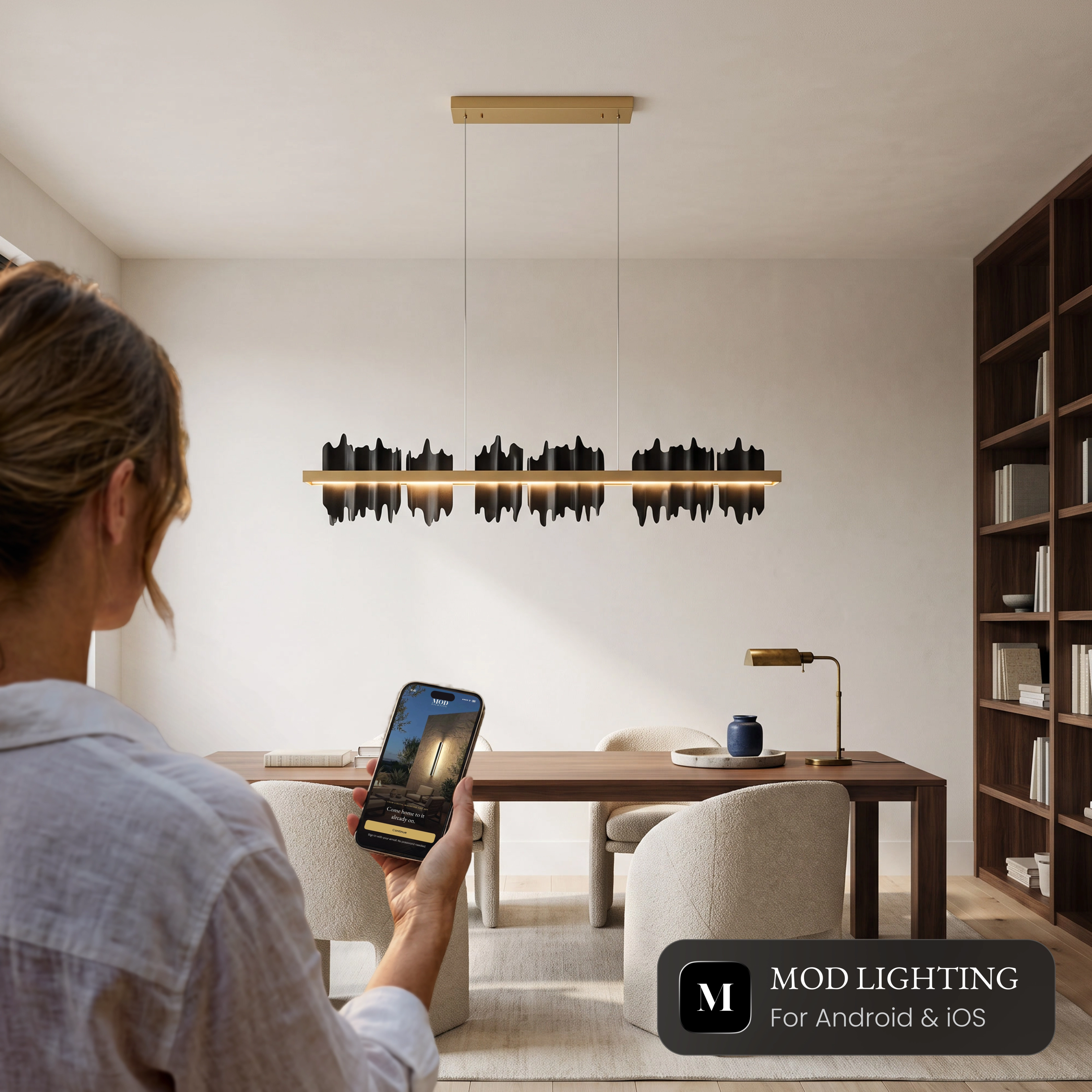Woman controlling the black Aurelius Pendant Smart from the MOD Smart Home app on her phone