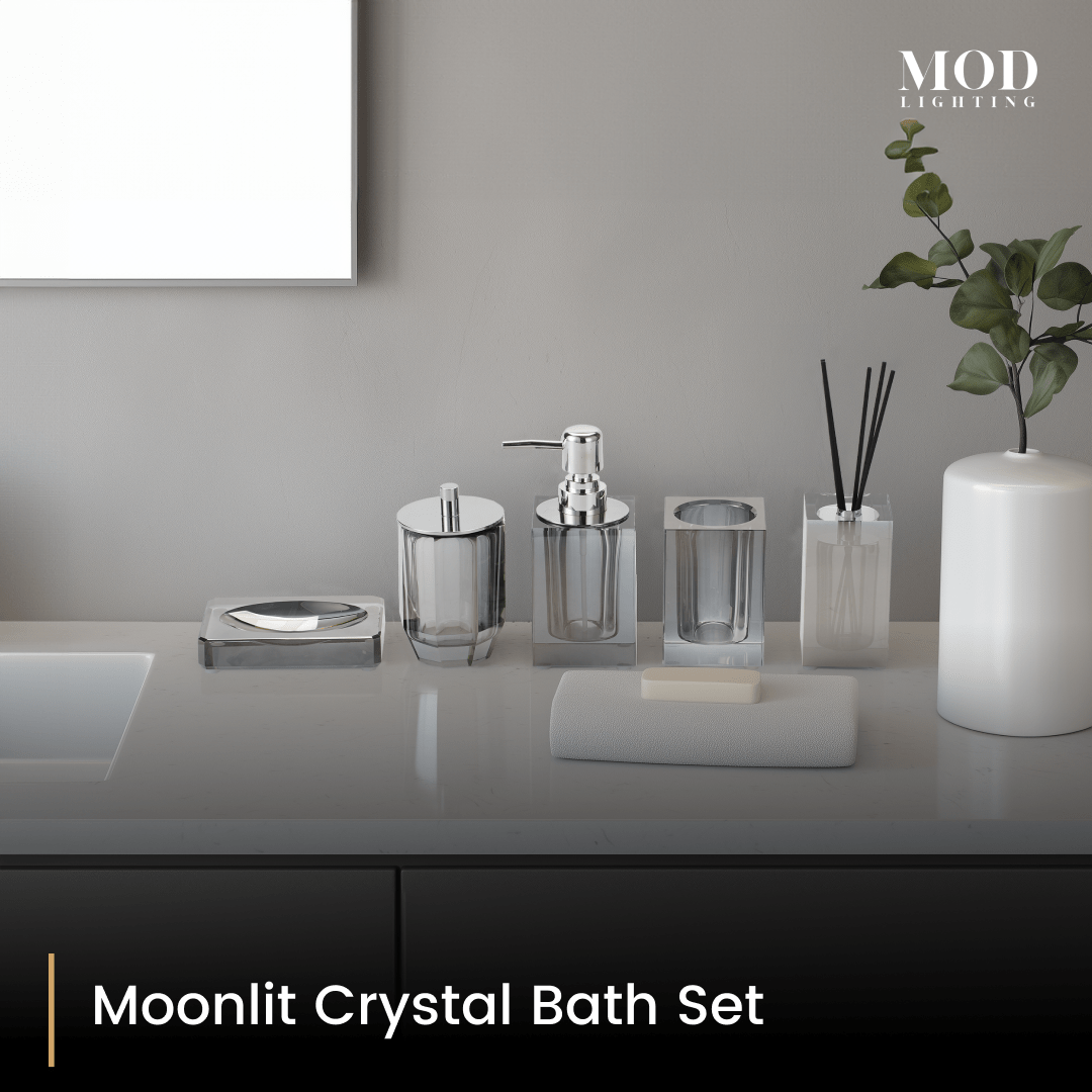 Moonlit Crystal Bath Set, smoky grey crystal soap pump, holder and jars lined up on a light grey vanity