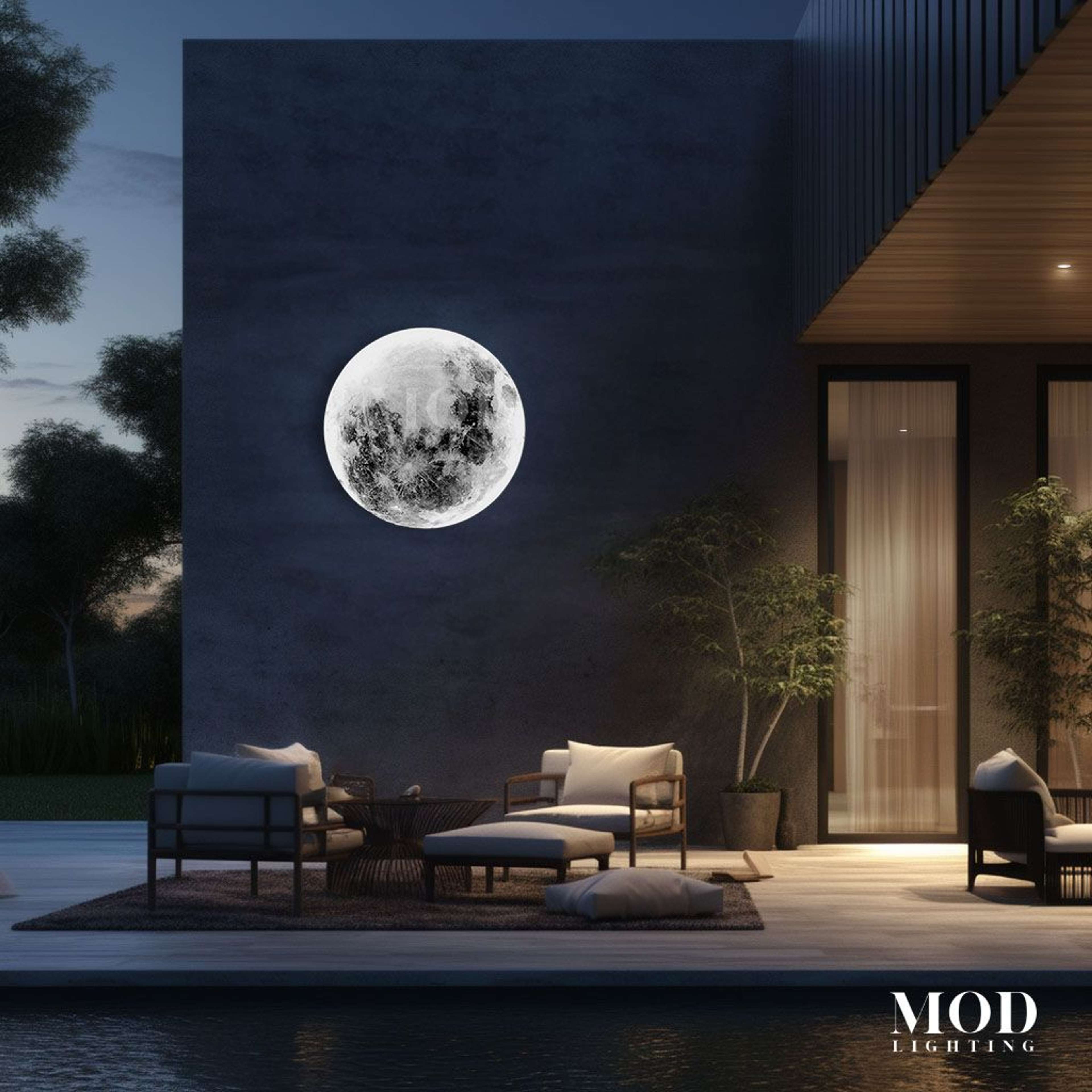 Luna round moon wall light glowing on an exterior wall above a patio seating area at dusk