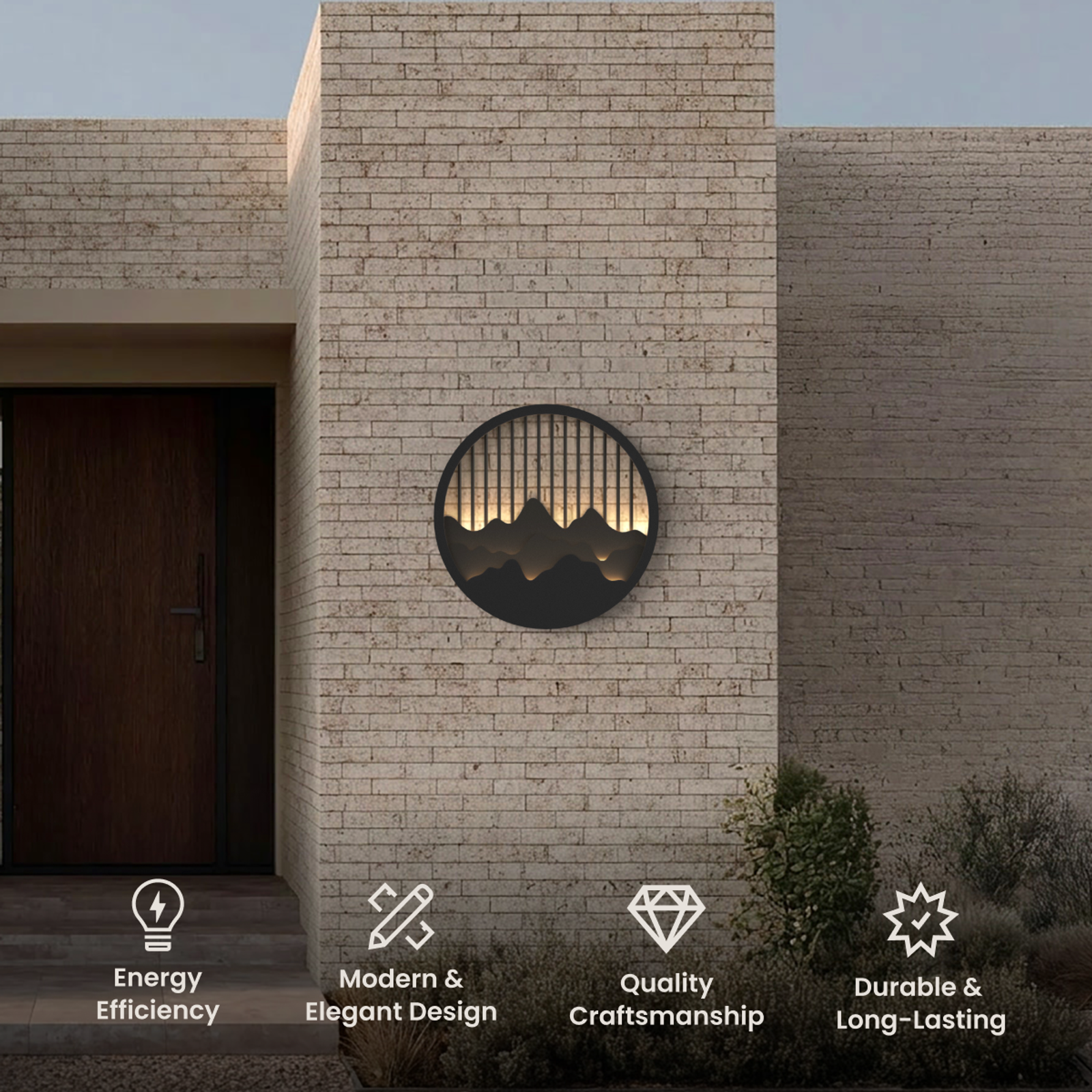 Valley outdoor wall light, round black disc with mountain-silhouette cutout glowing warm on brick facade