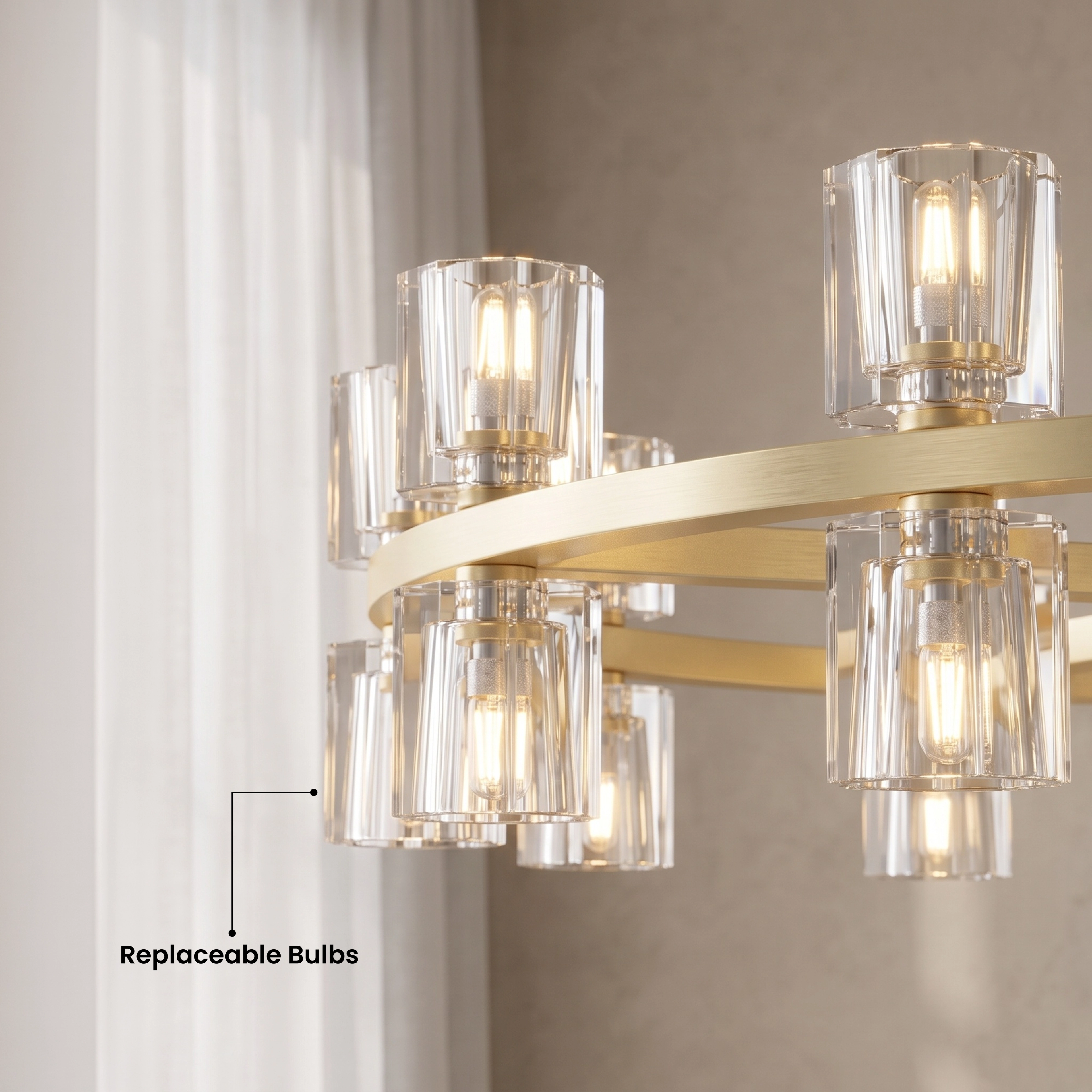 Sunrise brushed-gold ring chandelier with cube-cut crystal shades over a white seating area, warm-white glow