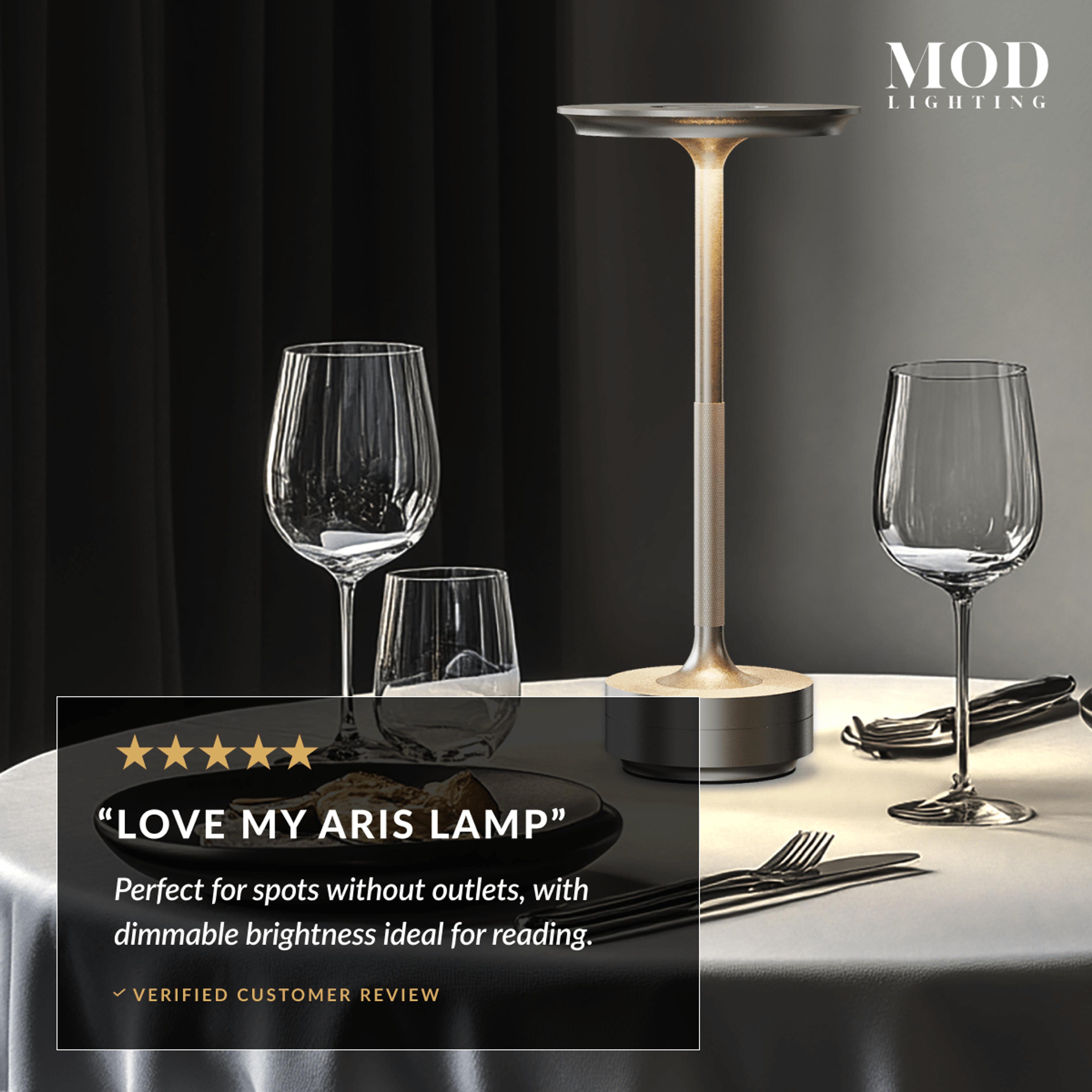 Aris brushed-gold rechargeable table lamp glowing on a dining table beside a five-star customer review