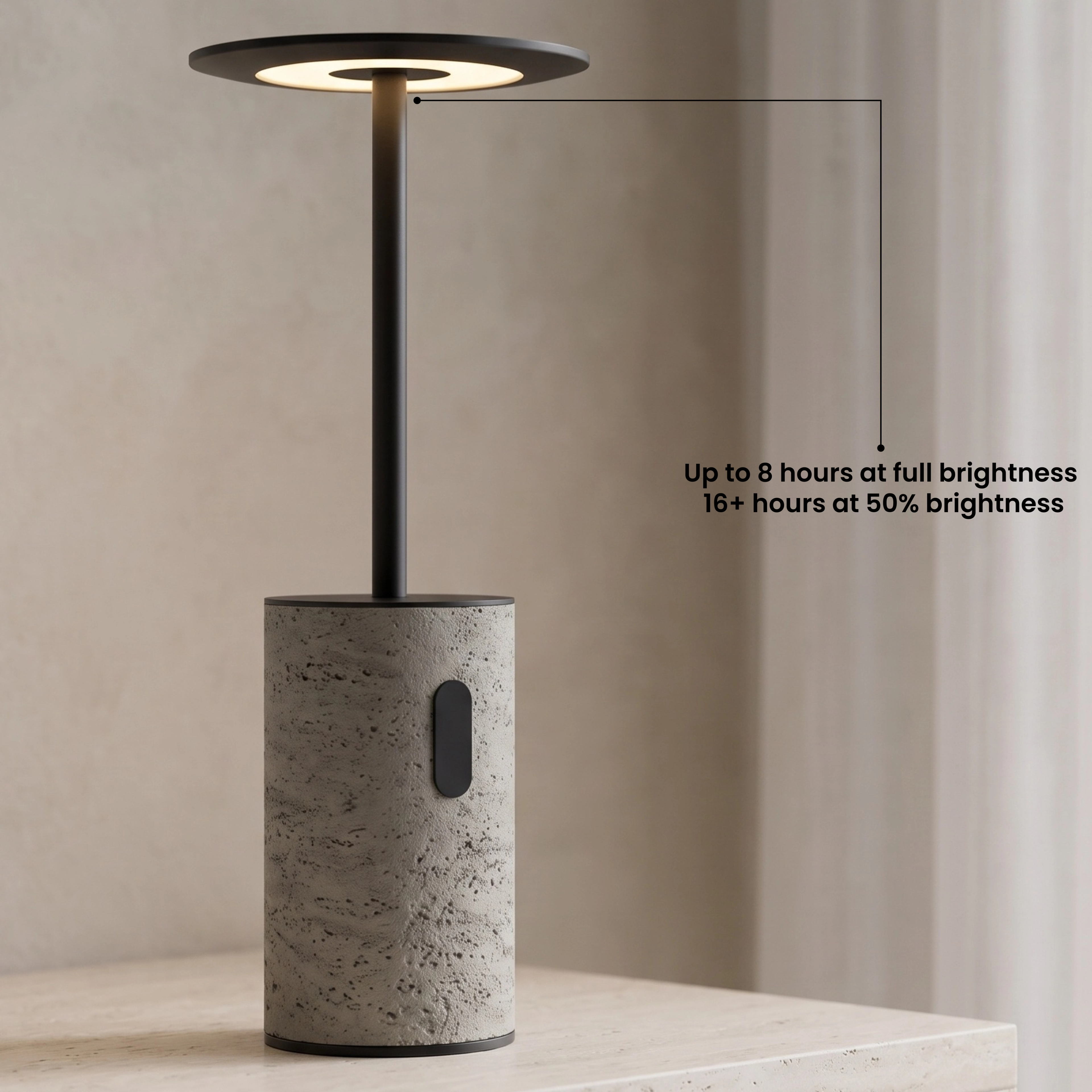 Vera table lamp with travertine base and black disc shade on a console beside a bed, glowing warm white