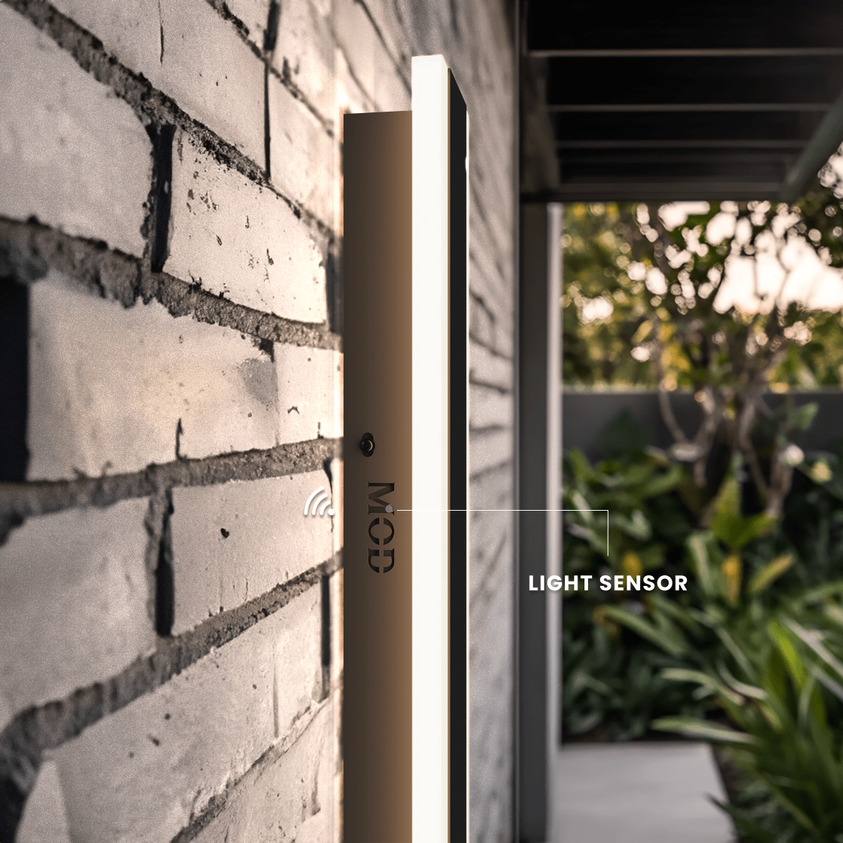 Haylen Sensor black LED bar wall light on a brick wall, close-up of its built-in light sensor