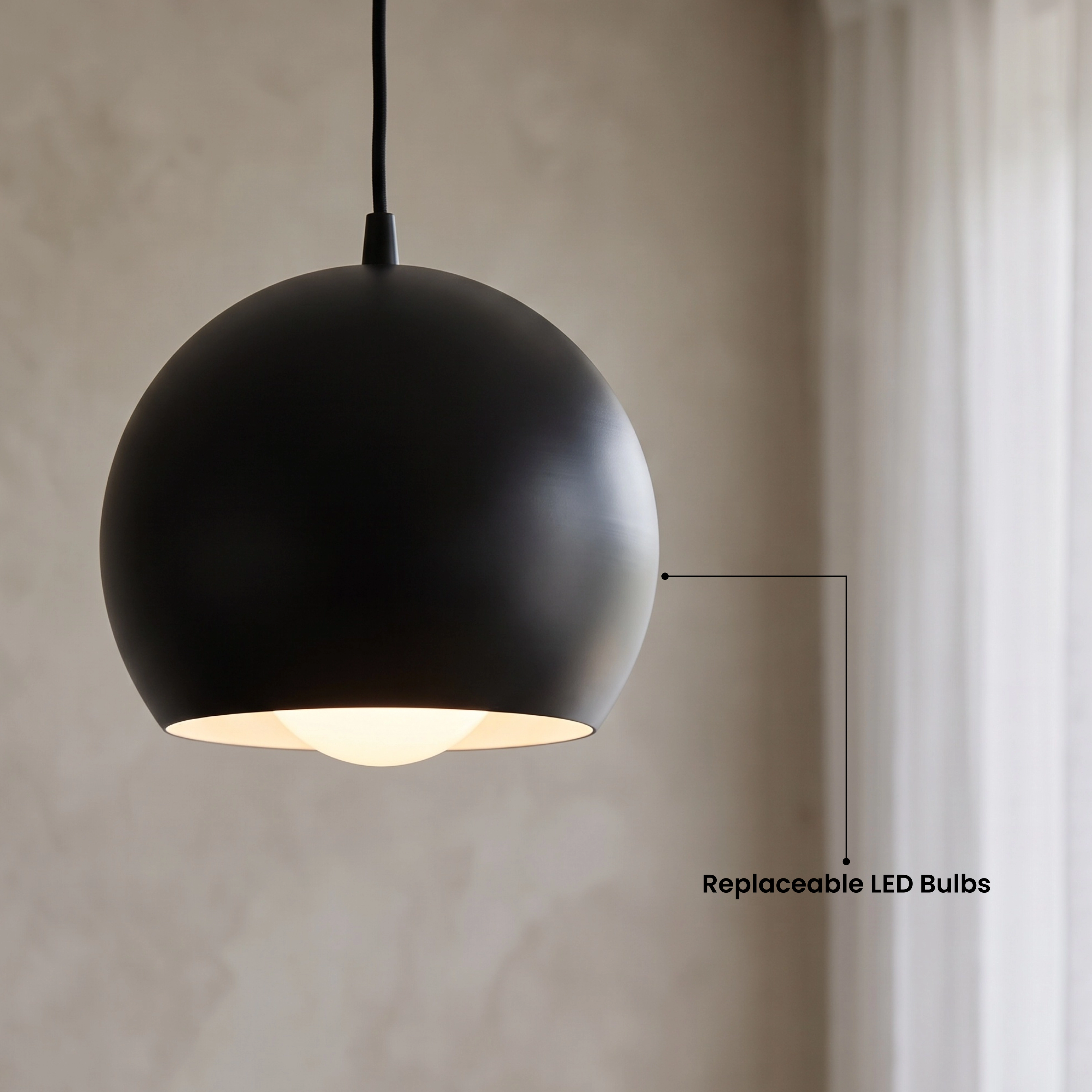 Avery black sphere pendant in a bedroom, labeled available in two finishes, warm white 3000K
