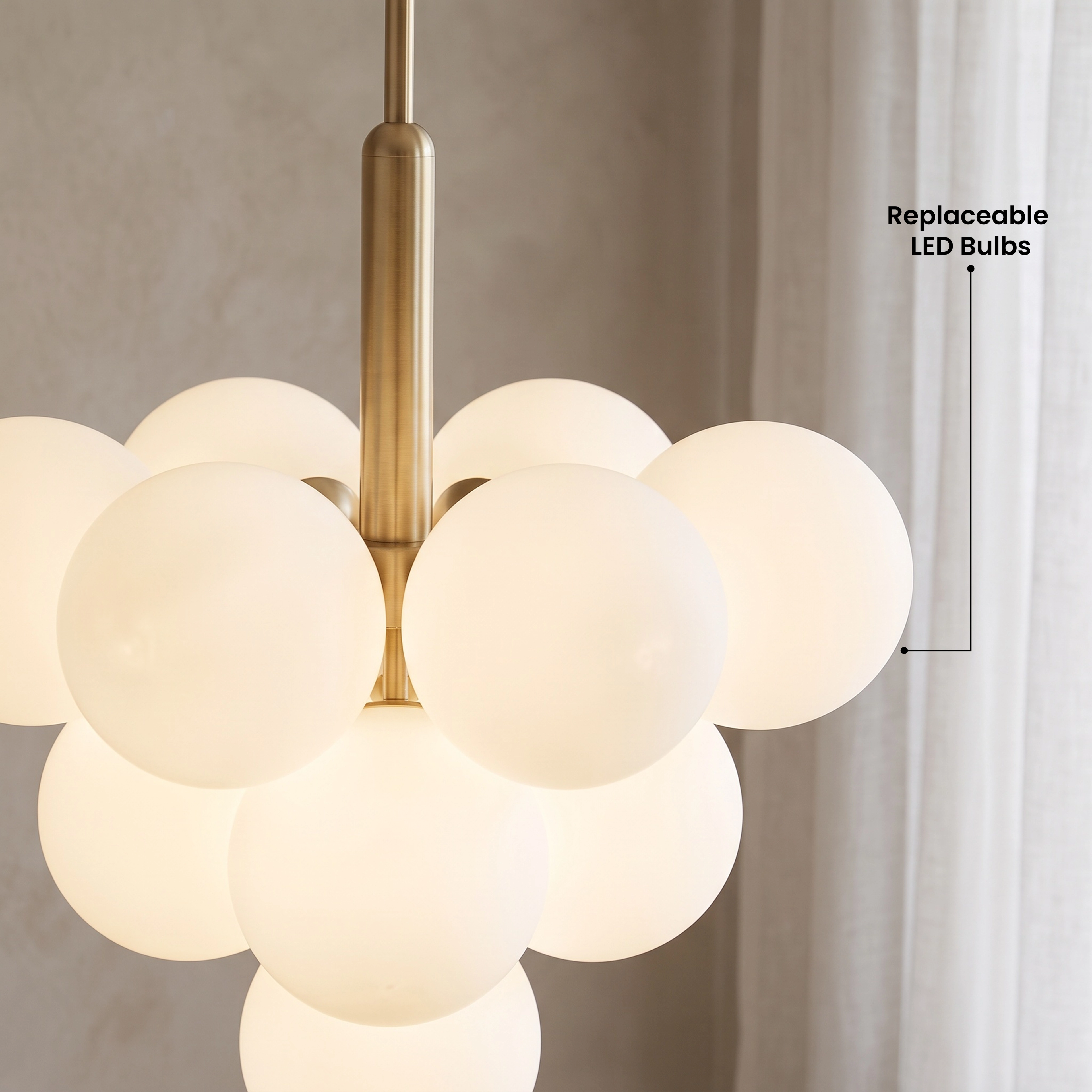 Angelica gold pendant, four white opal-glass globes on a brass rod, in a paneled stairway hall