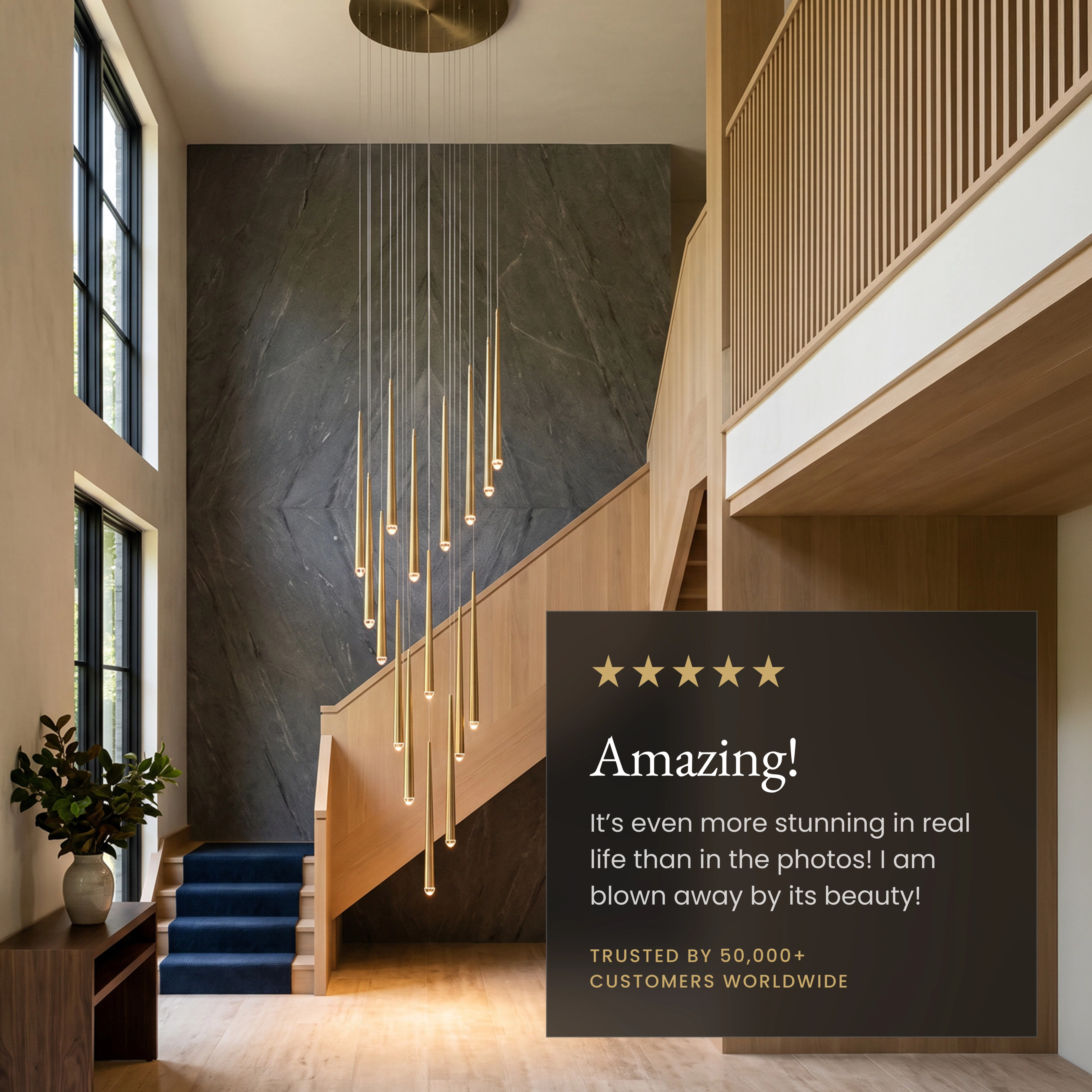 Jasper gold slim rod pendants spiraling from a high ceiling above a lounge chair and ottoman