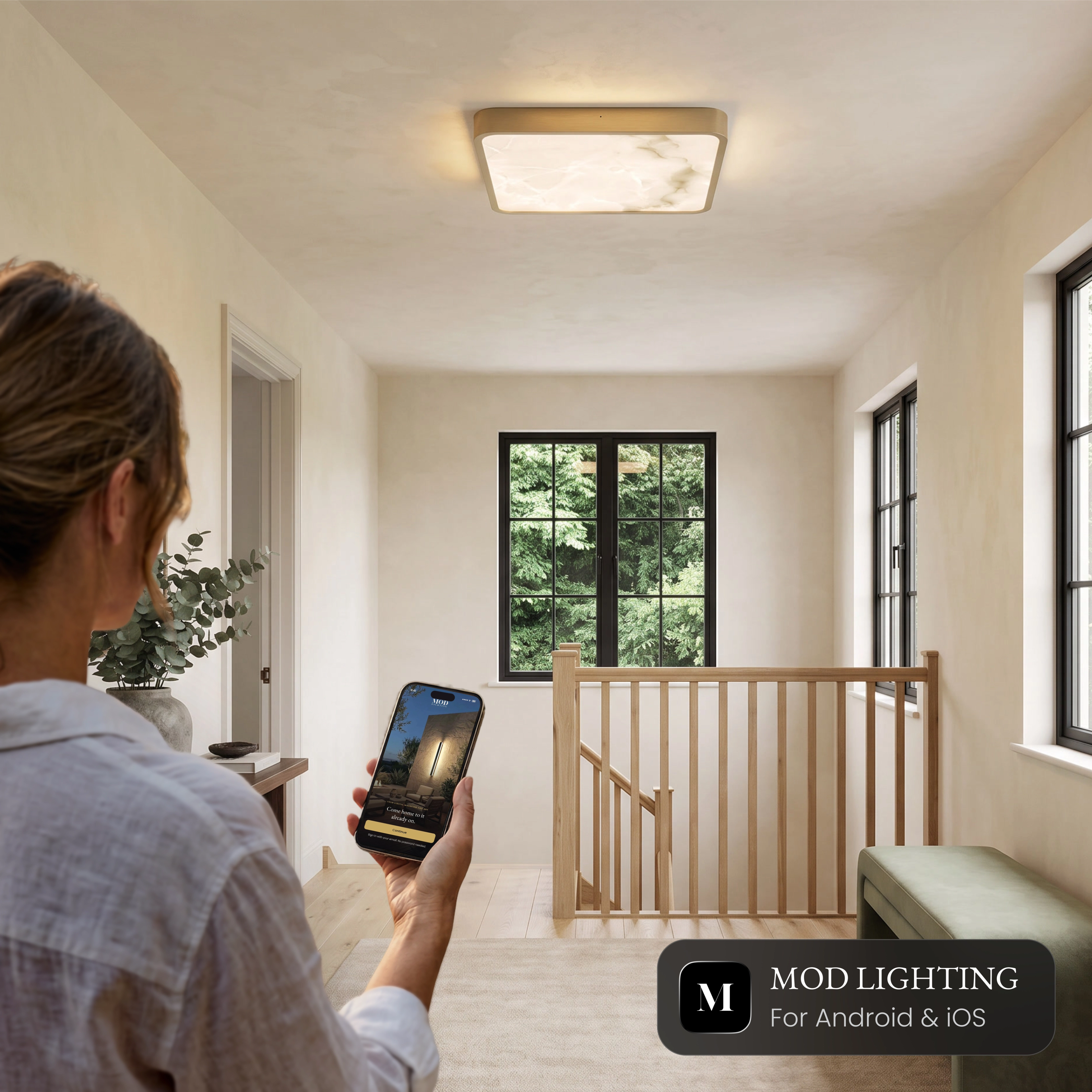 Selene Smart square alabaster ceiling light on a landing, controlled from the MOD LIGHTING app on a phone