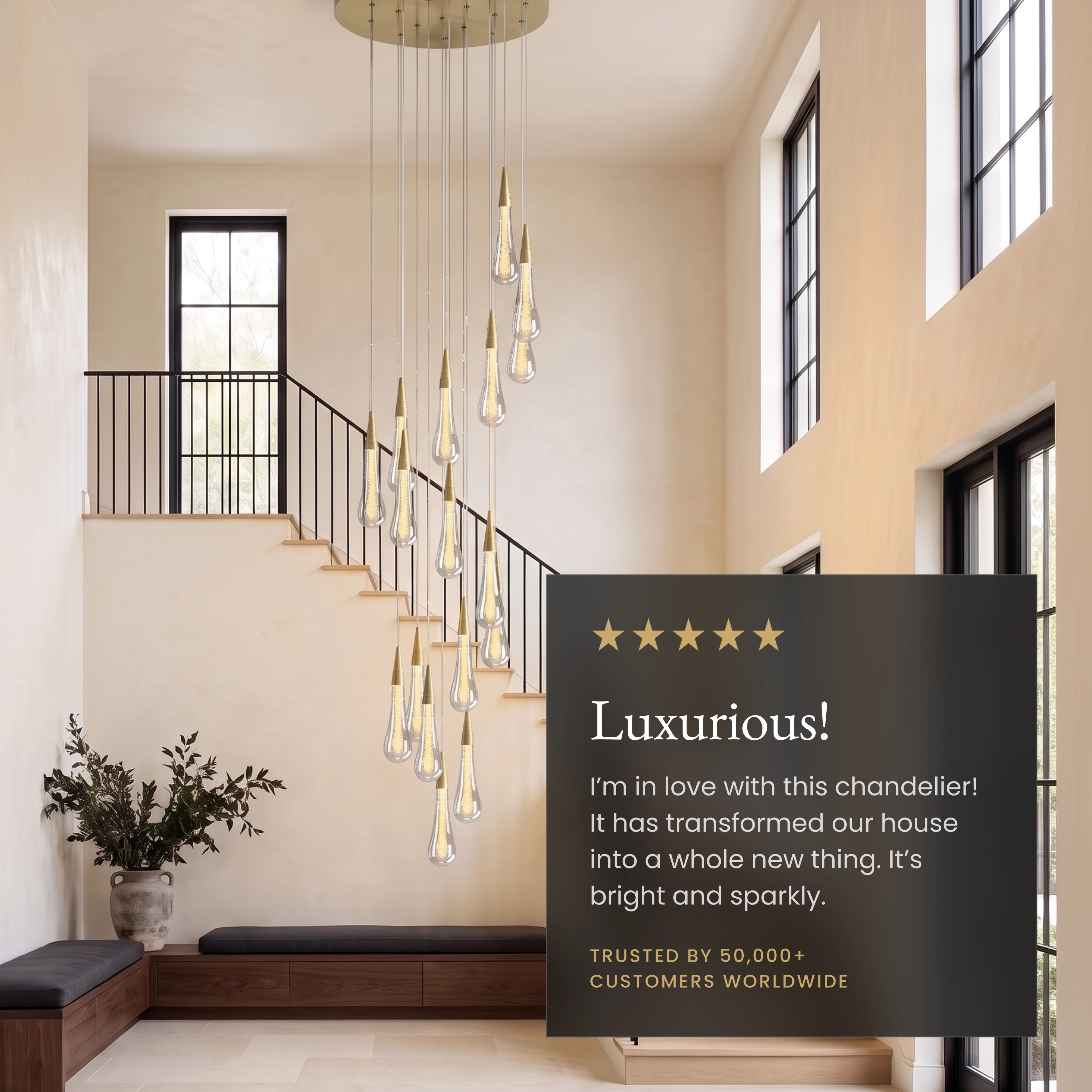 Indra chandelier, gold crystal teardrops cascading beside a curved staircase