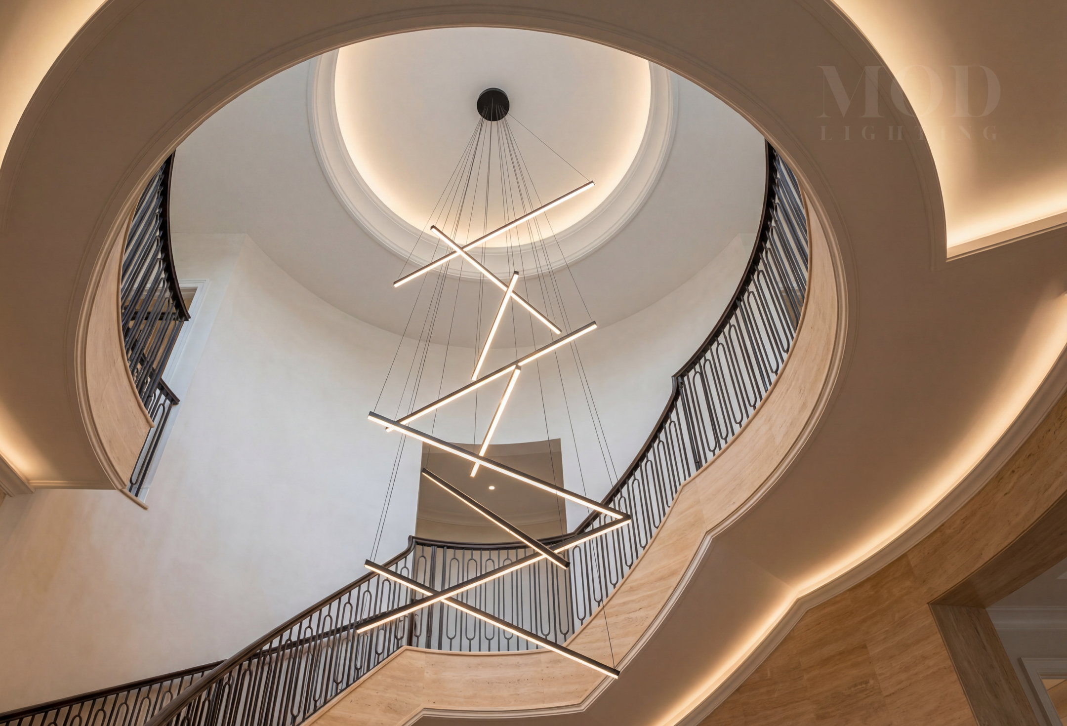 Large geometric chandelier viewed from below in a double-height foyer