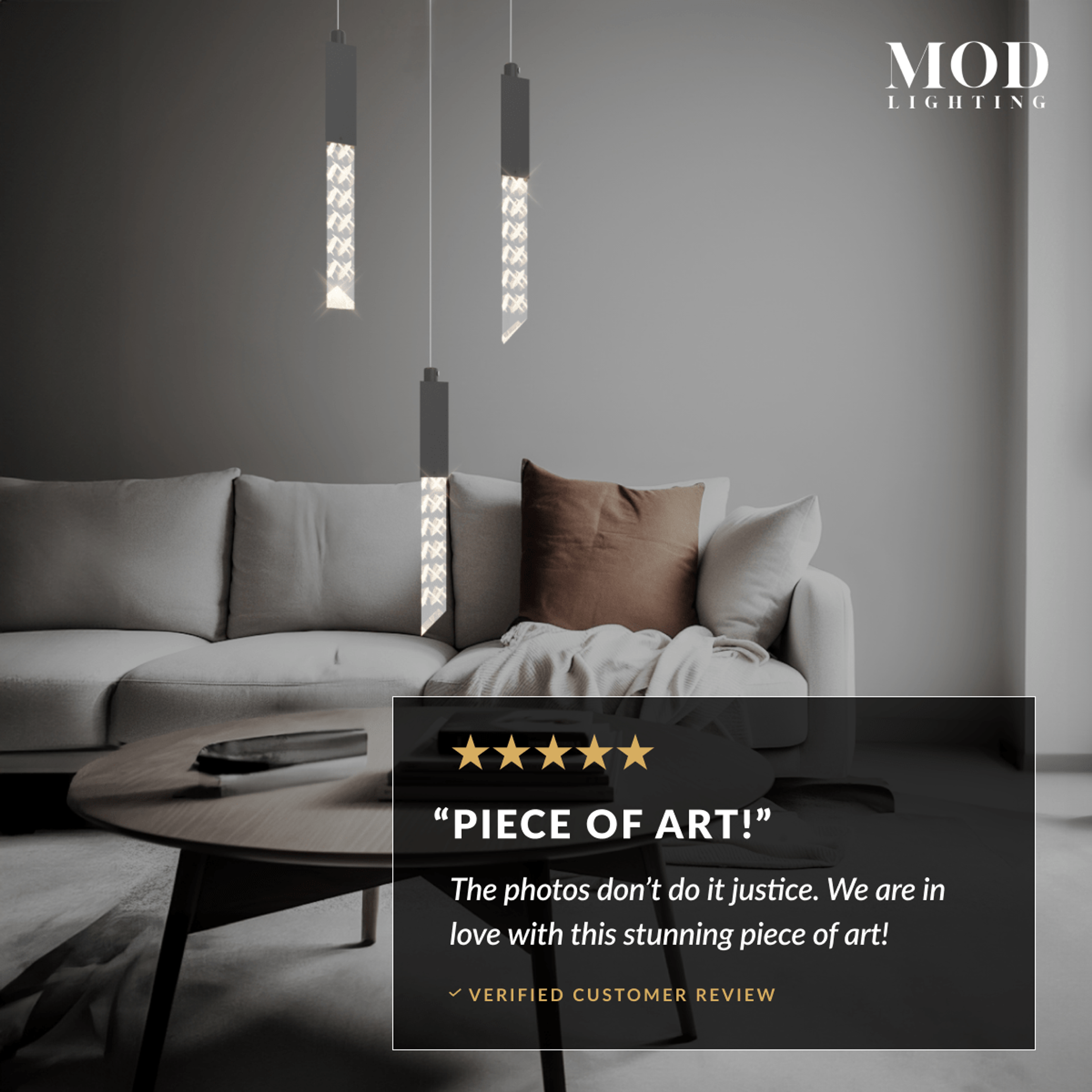 Cosmo black crystal-bar pendants, two slim glowing rods hanging beside a sofa in a gray living room