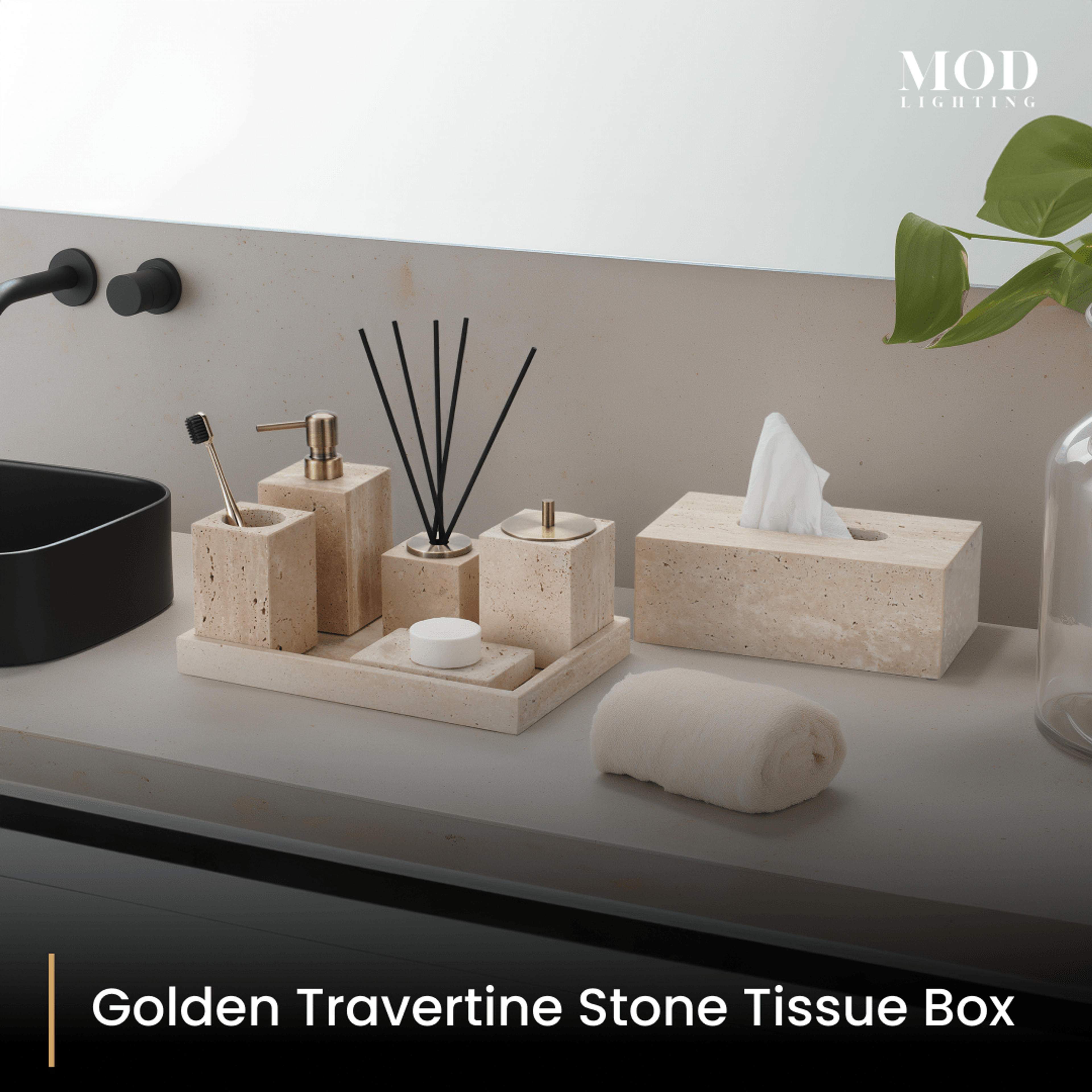 Golden Travertine tissue box and bath set on a tray on a grey vanity with black tap and plant