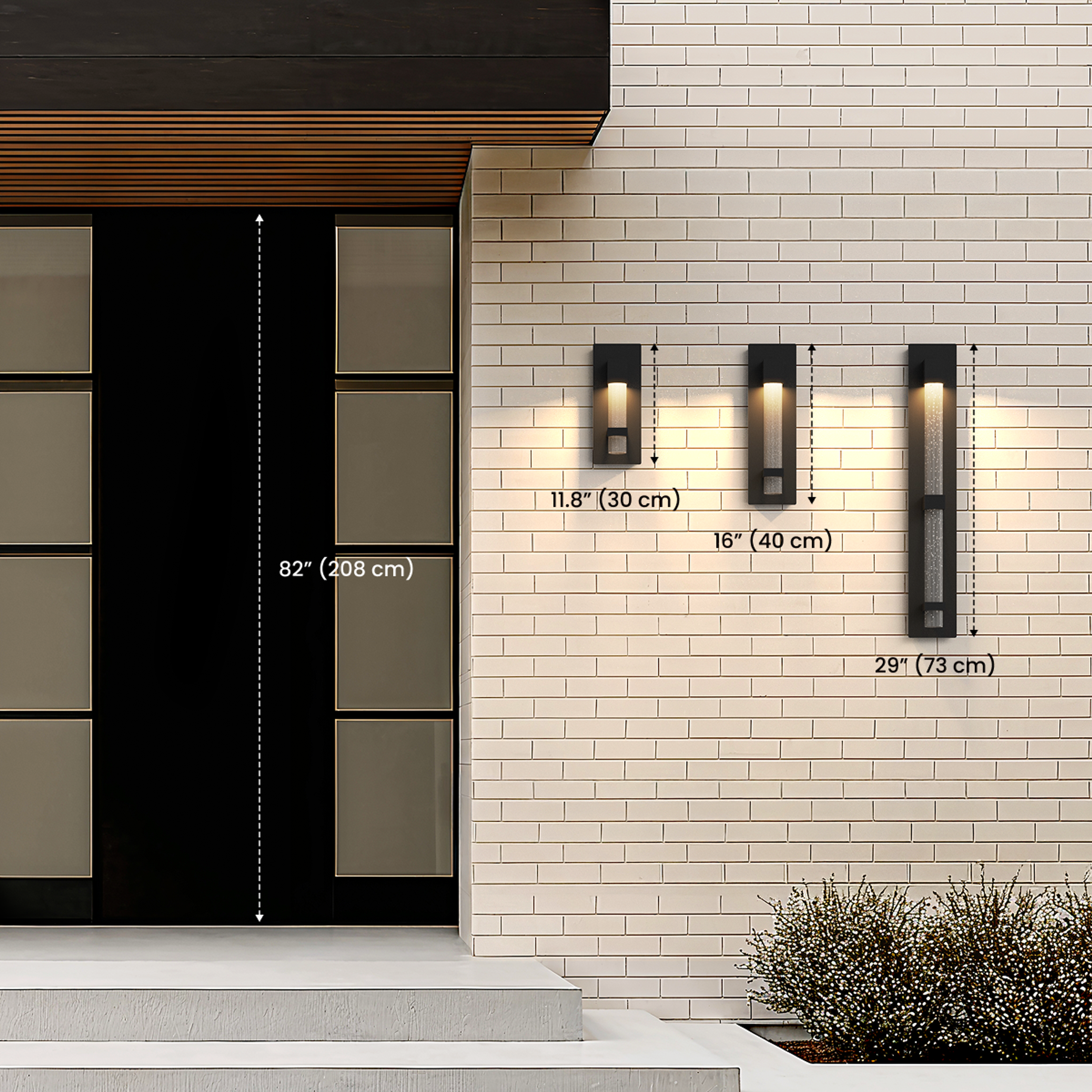 Three sizes of Astra black outdoor sconces by a door, diagram noting 11.8 in / 30 cm, 16 in / 40 cm and 29 in / 73 cm