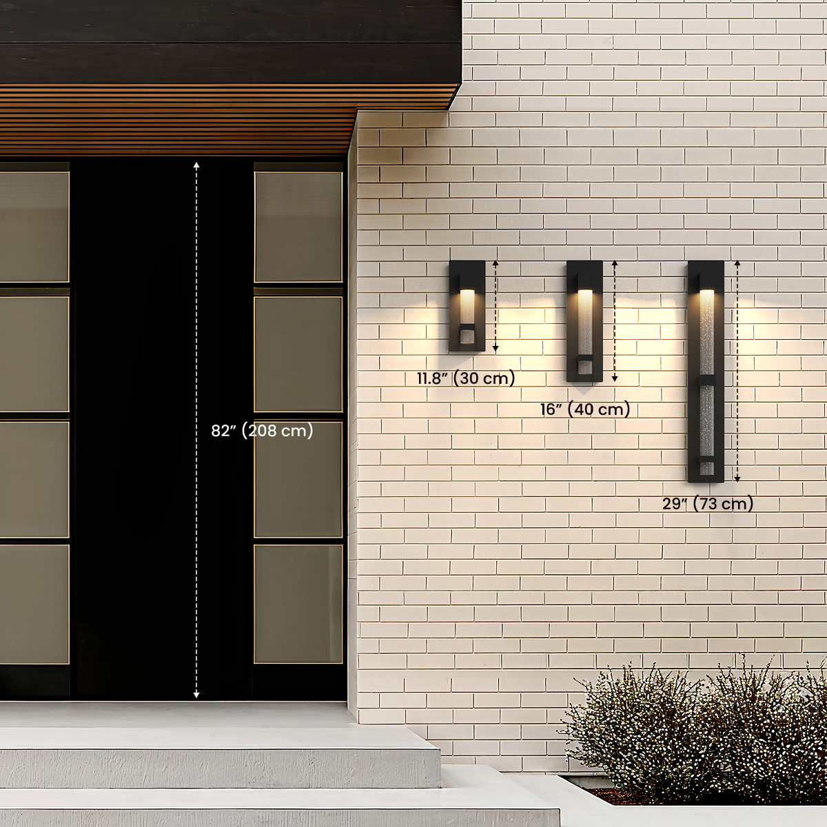 Three sizes of Astra black outdoor sconces by a door, diagram noting 11.8 in / 30 cm, 16 in / 40 cm and 29 in / 73 cm