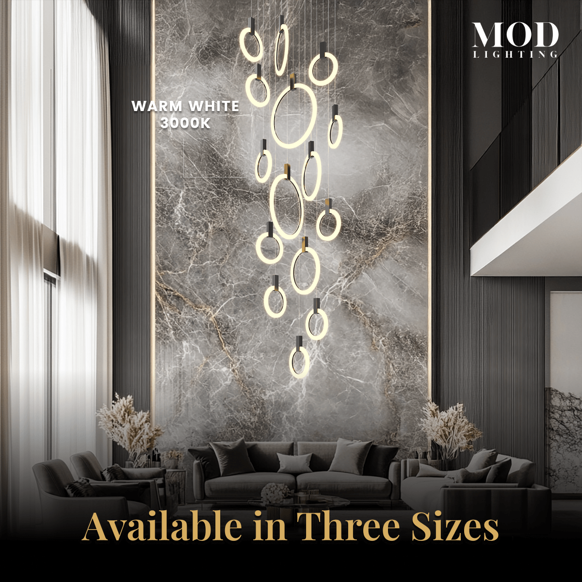Skyla chandelier, warm white 3000K lit rings cascading against a marble feature wall over a sofa