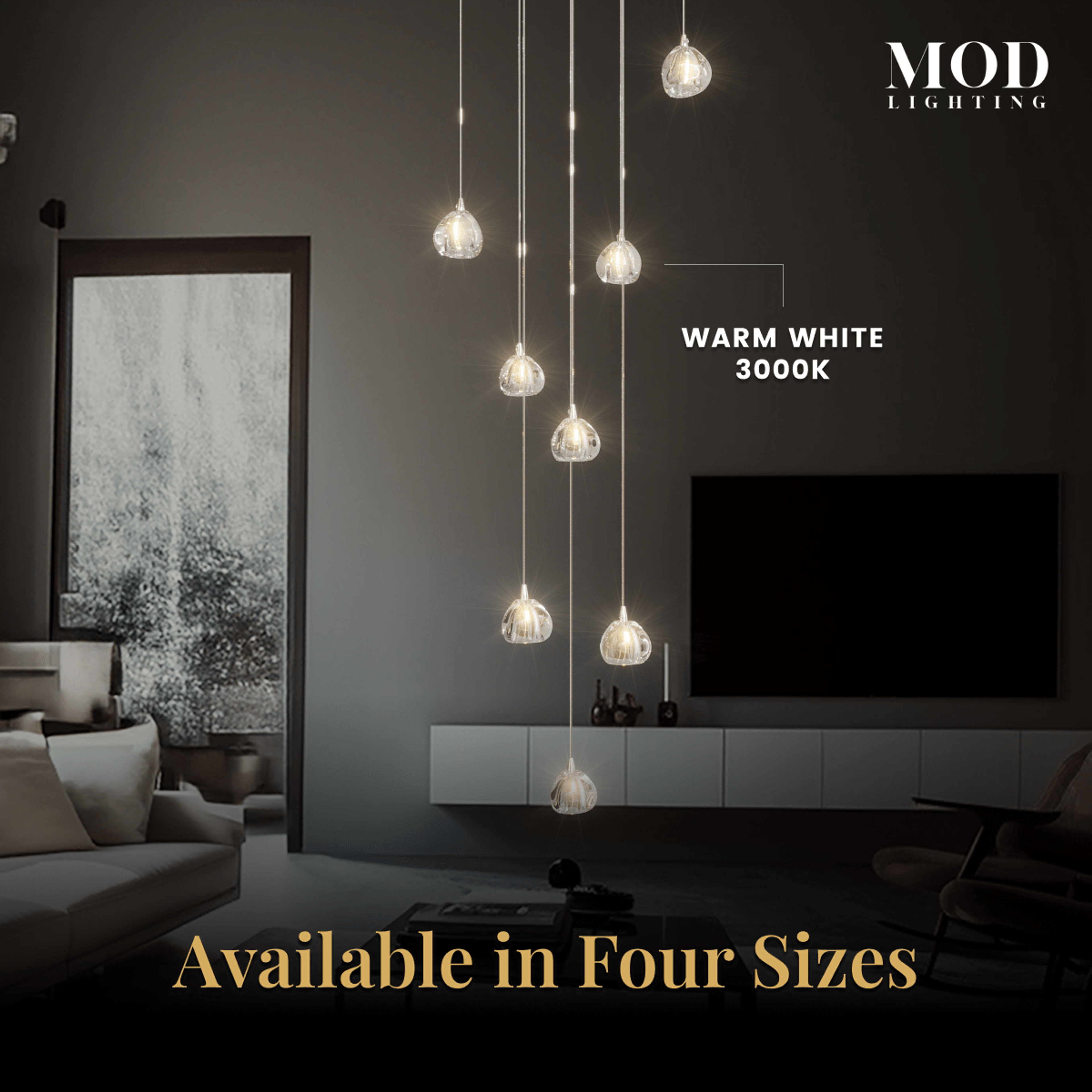 Sage clear-glass globe pendants cascading in four sizes over a media console and sofa