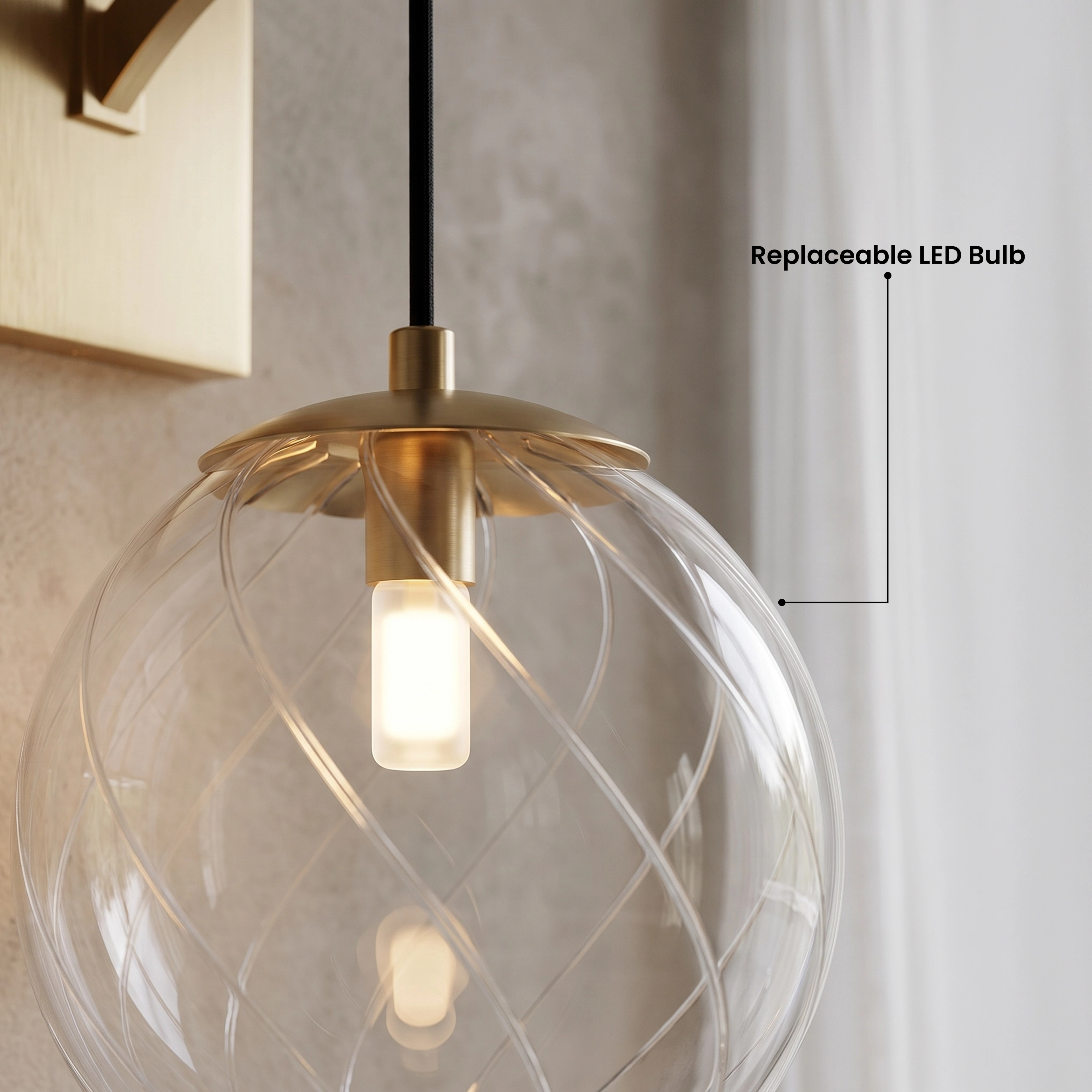Mirella Sconce, brushed-gold globe wall light in warm white 3000K, on a pale plaster wall above florals