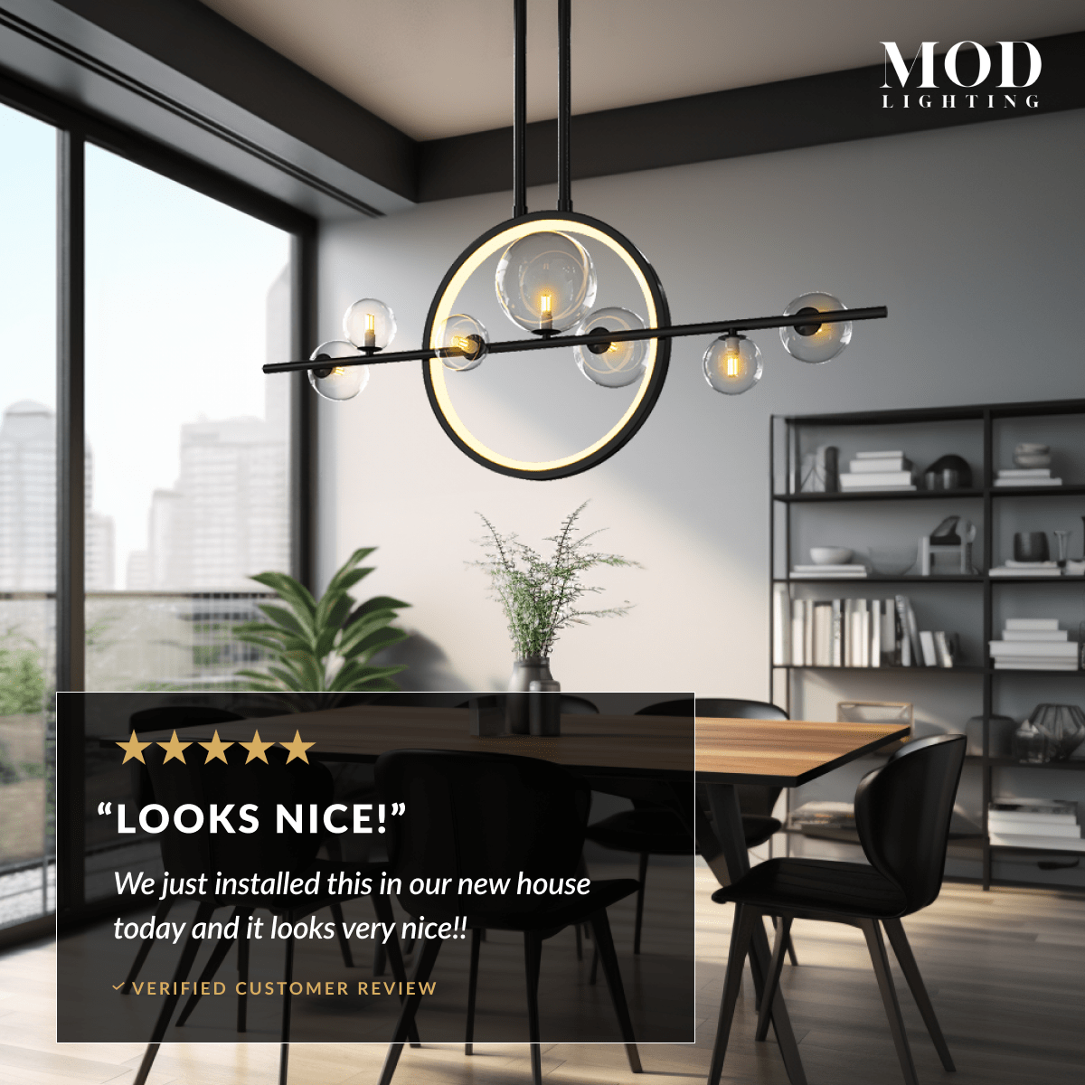 Hailey Nordic chandelier, black bar with gold ring and glass globes, above a dining table by a window