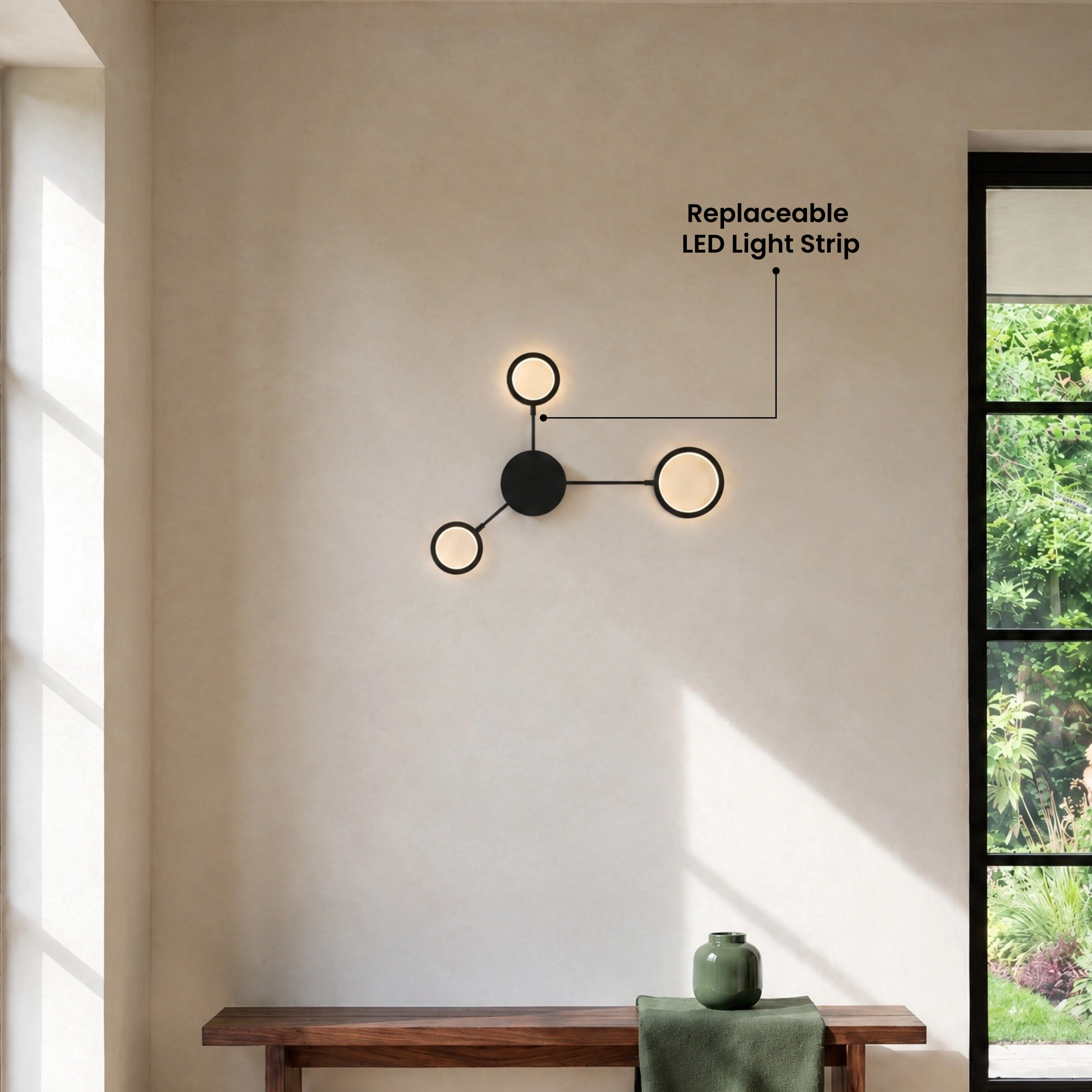 Link wall light, black arms and gold discs, warm white, mounted above a bed headboard