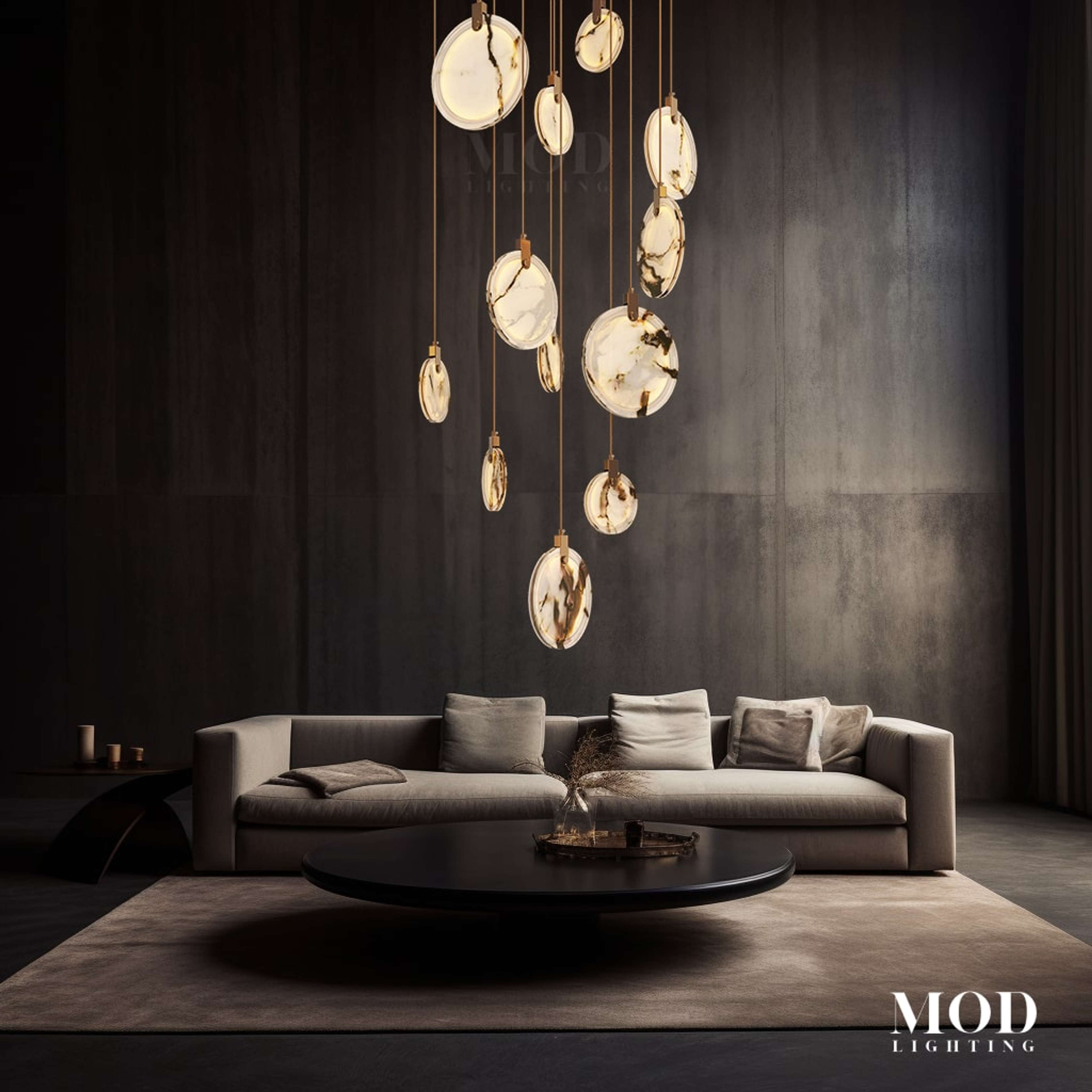 Marble gold-veined alabaster disc pendant cluster suspended over a sofa and coffee table in a dark modern living room