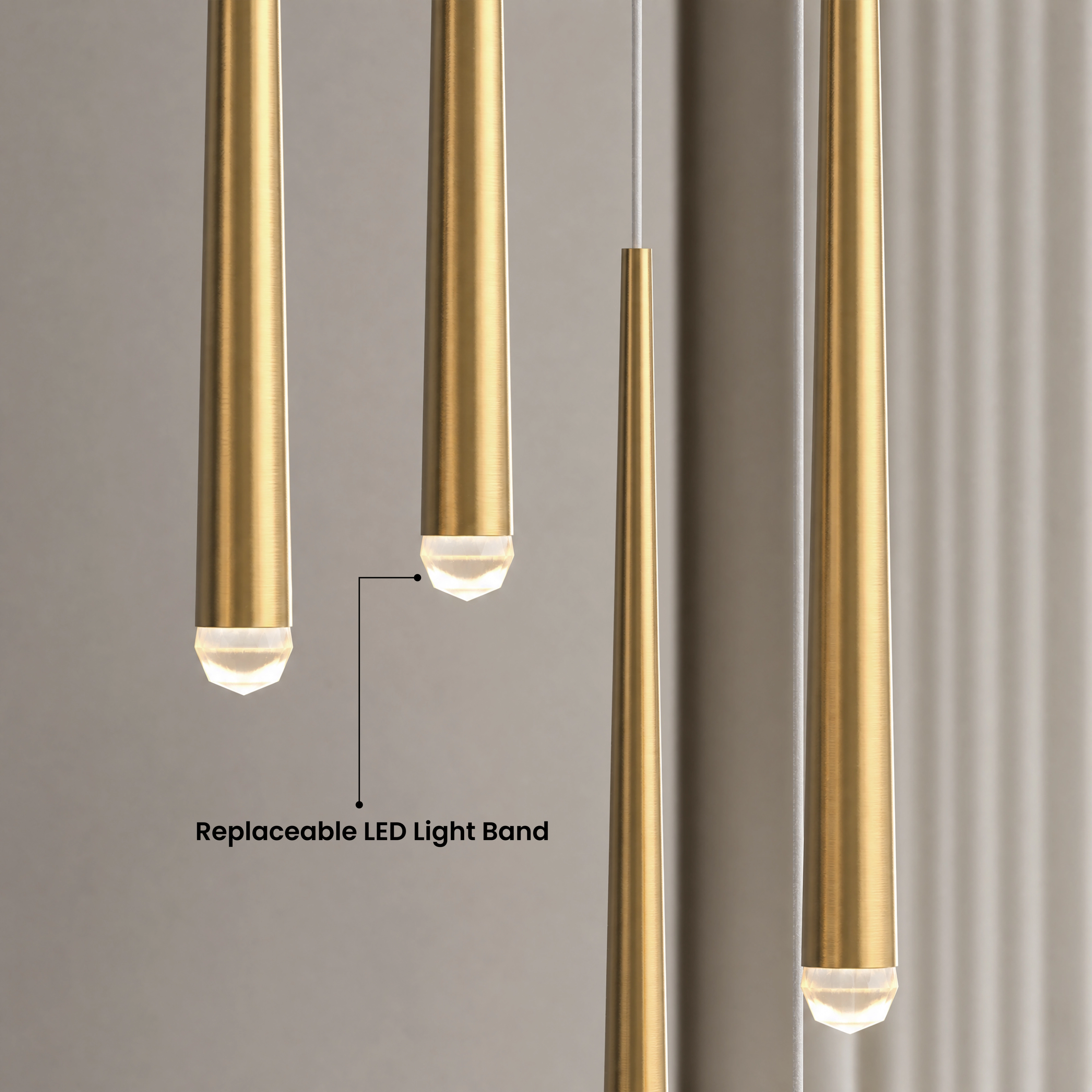 Jasper gold tapered pendants cascading in four sizes beside a sofa in a warm neutral room