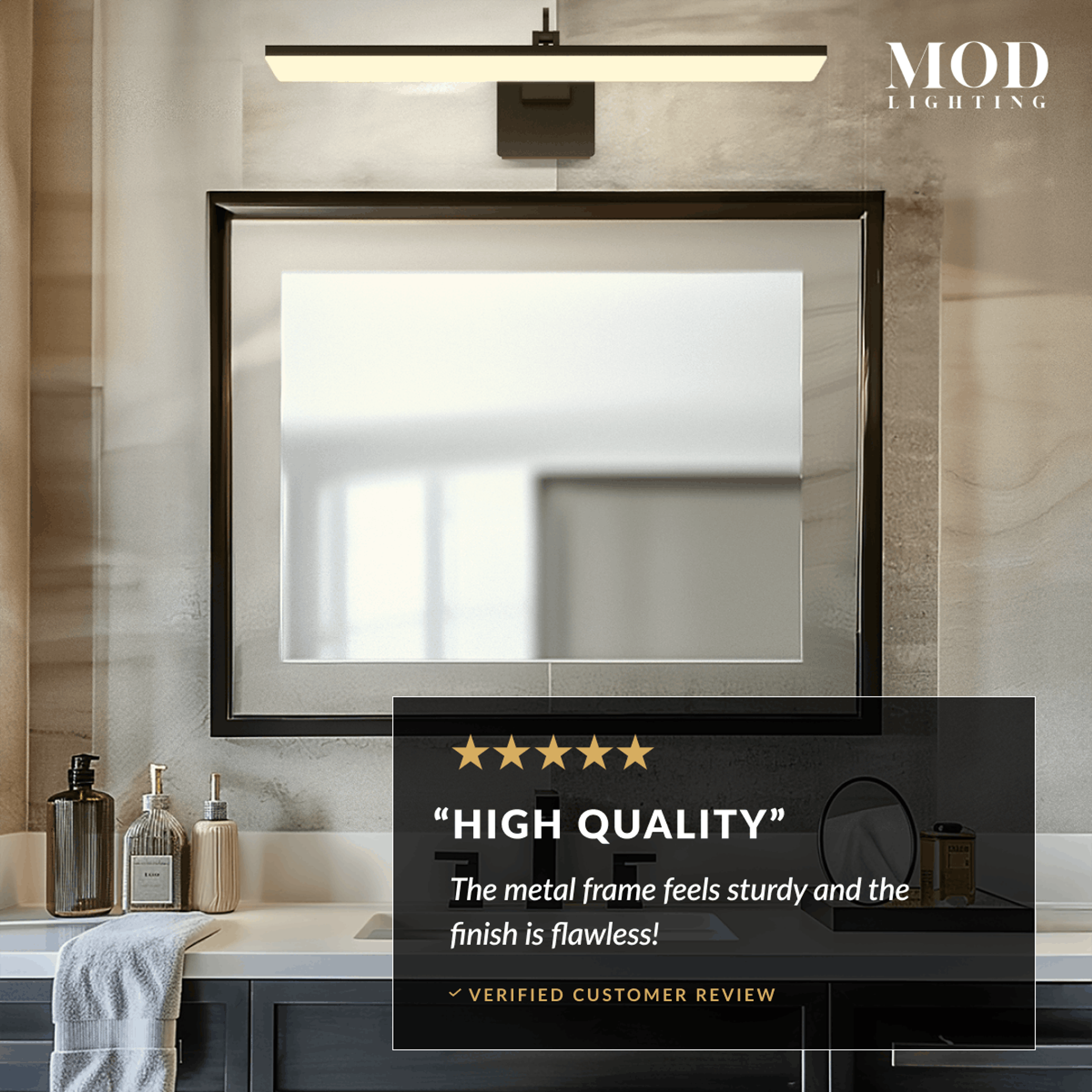 Zena slim black horizontal bar light glowing above a framed mirror in a marble bathroom, with review callout