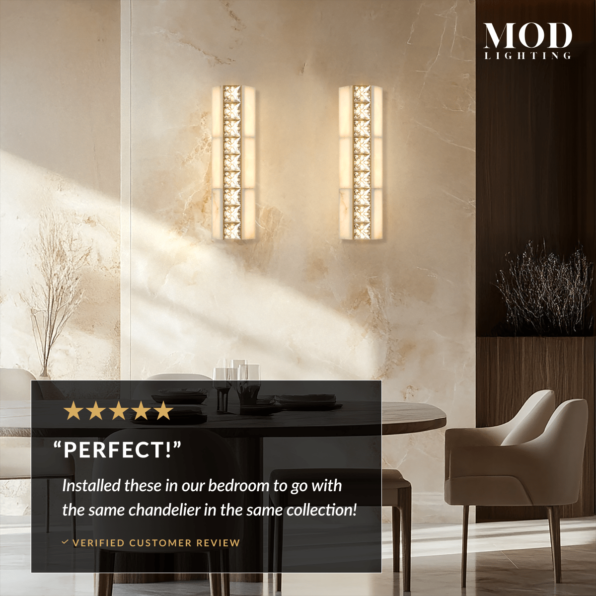 Two Seraphine Sconce gold alabaster crystal wall lights flanking a marble wall by a dining area