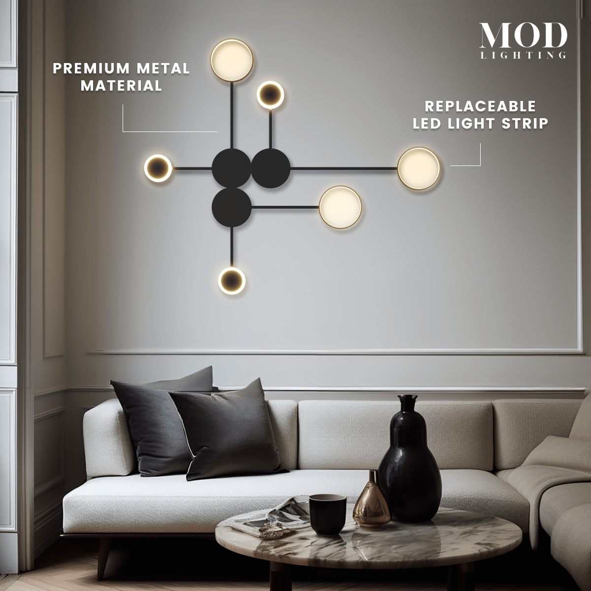 Link wall light, black rods linking circular gold discs, mounted on a wall beside a curved chair