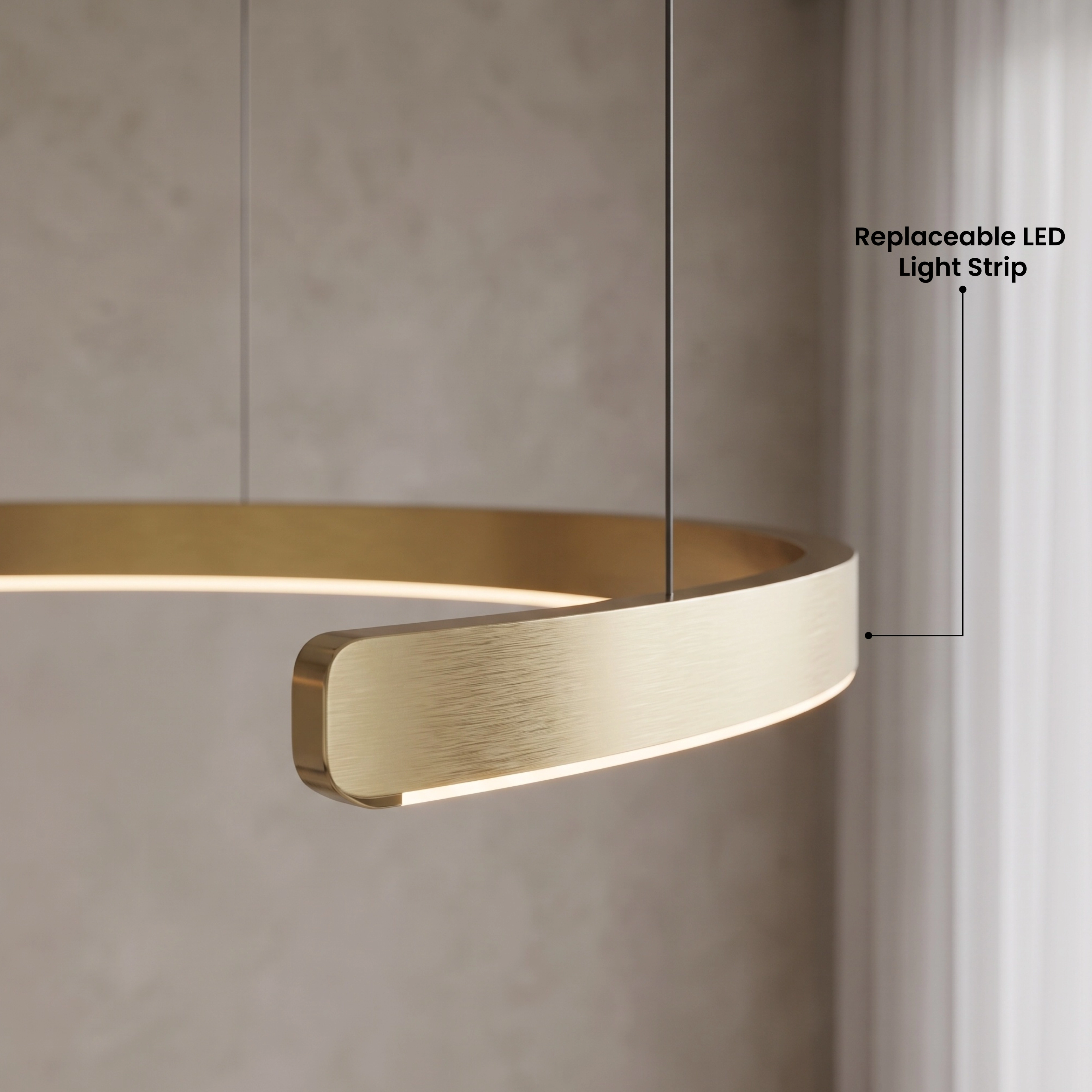 Ring chandelier in gold, two circular band pendants over a dining table with warm white light in a grey room