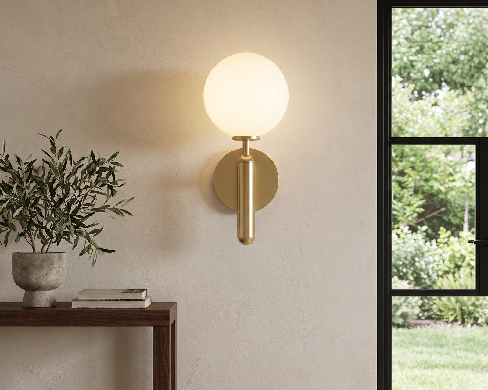 Brass globe wall sconce beside a window
