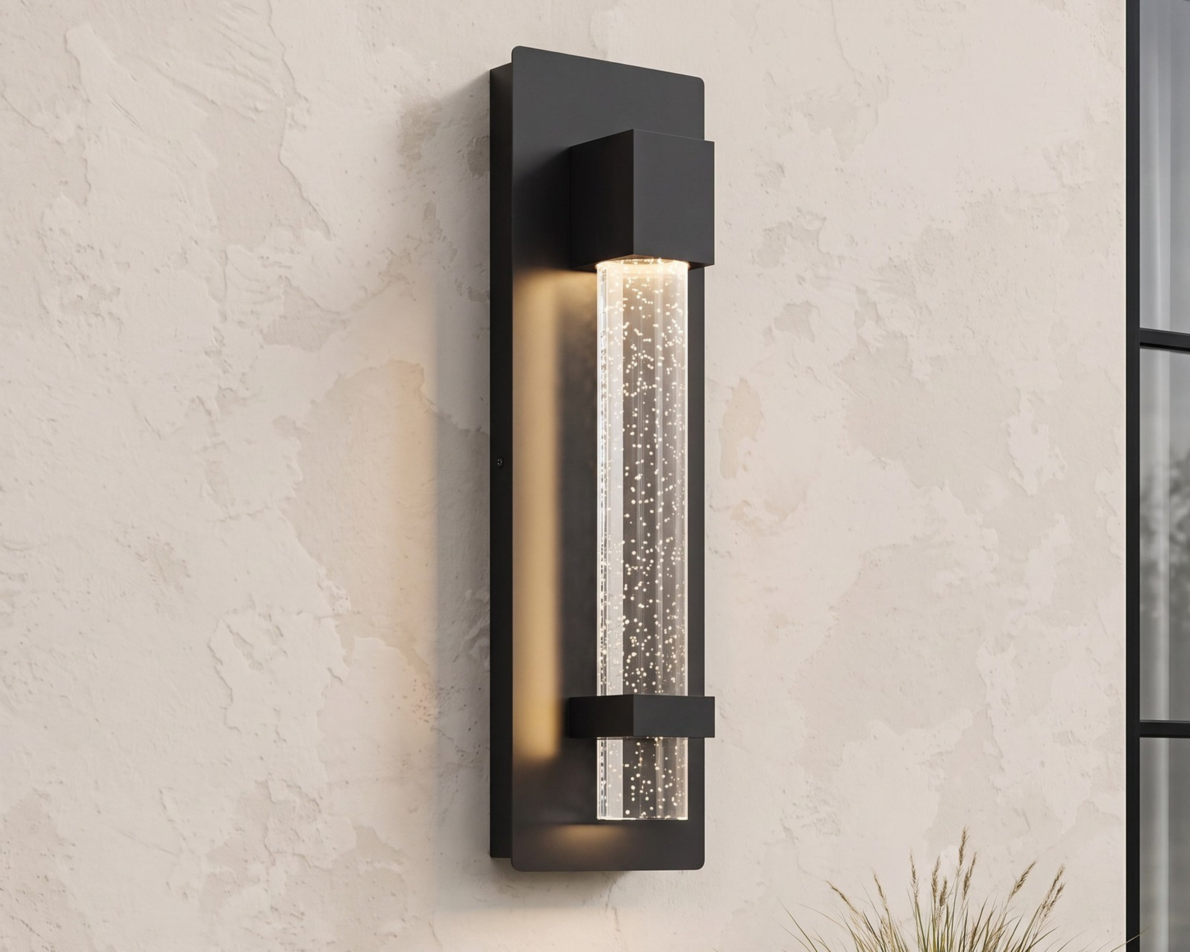 Astra, a slim outdoor wall sconce, on a limewash facade