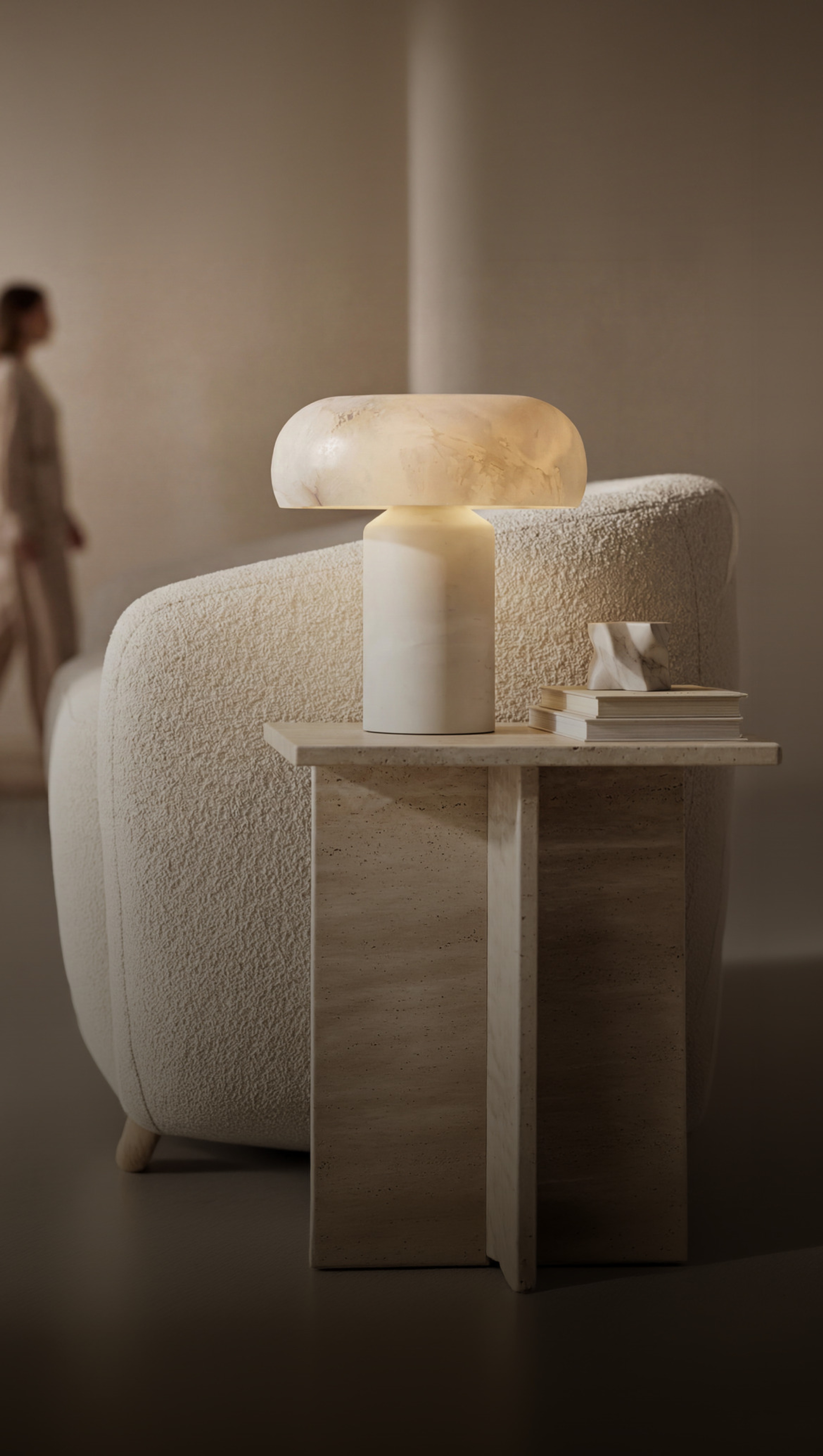 MOD LIGHTING alabaster table lamp on a travertine side table in a warm modern living room