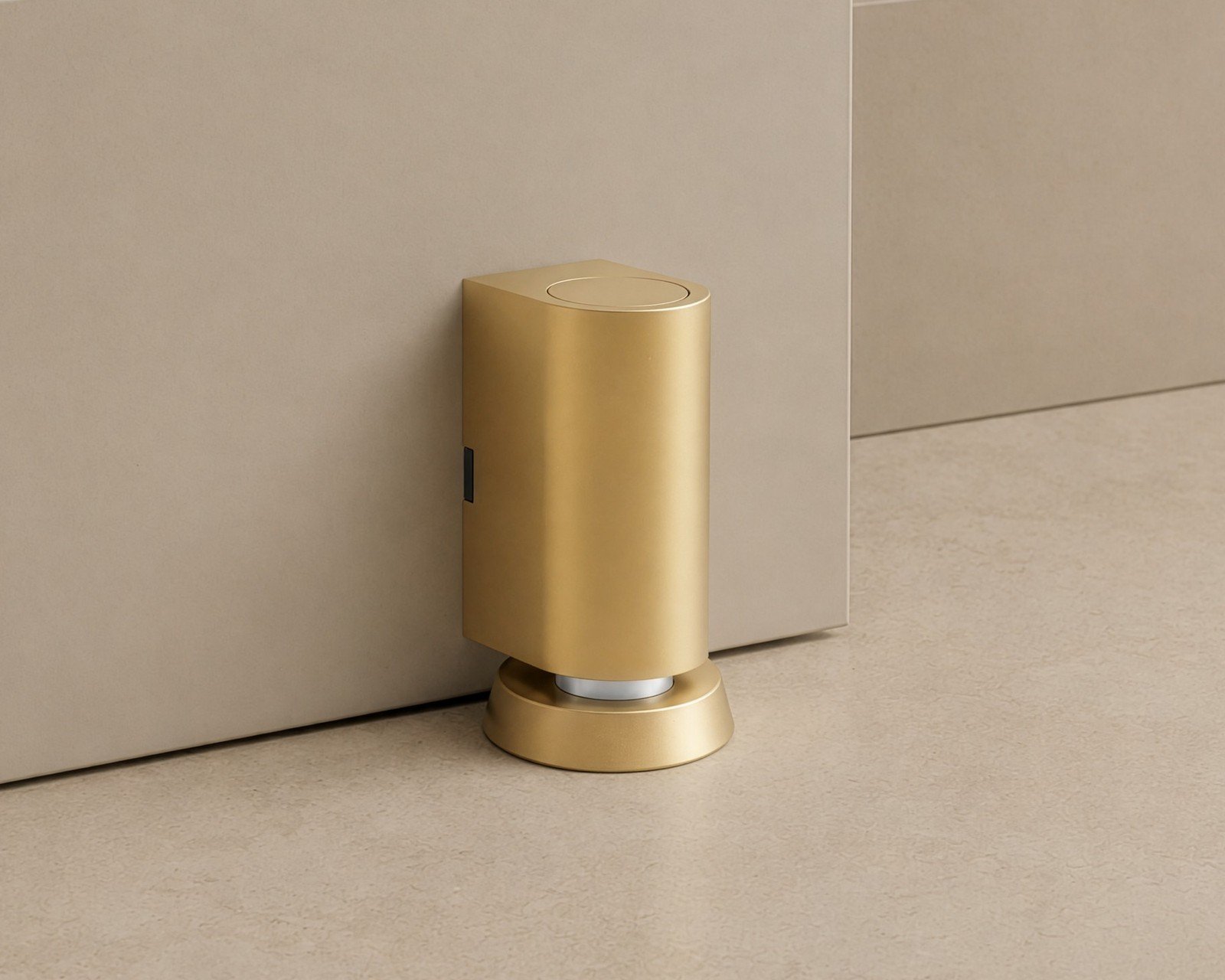 Cavo brass door stop on a beige floor