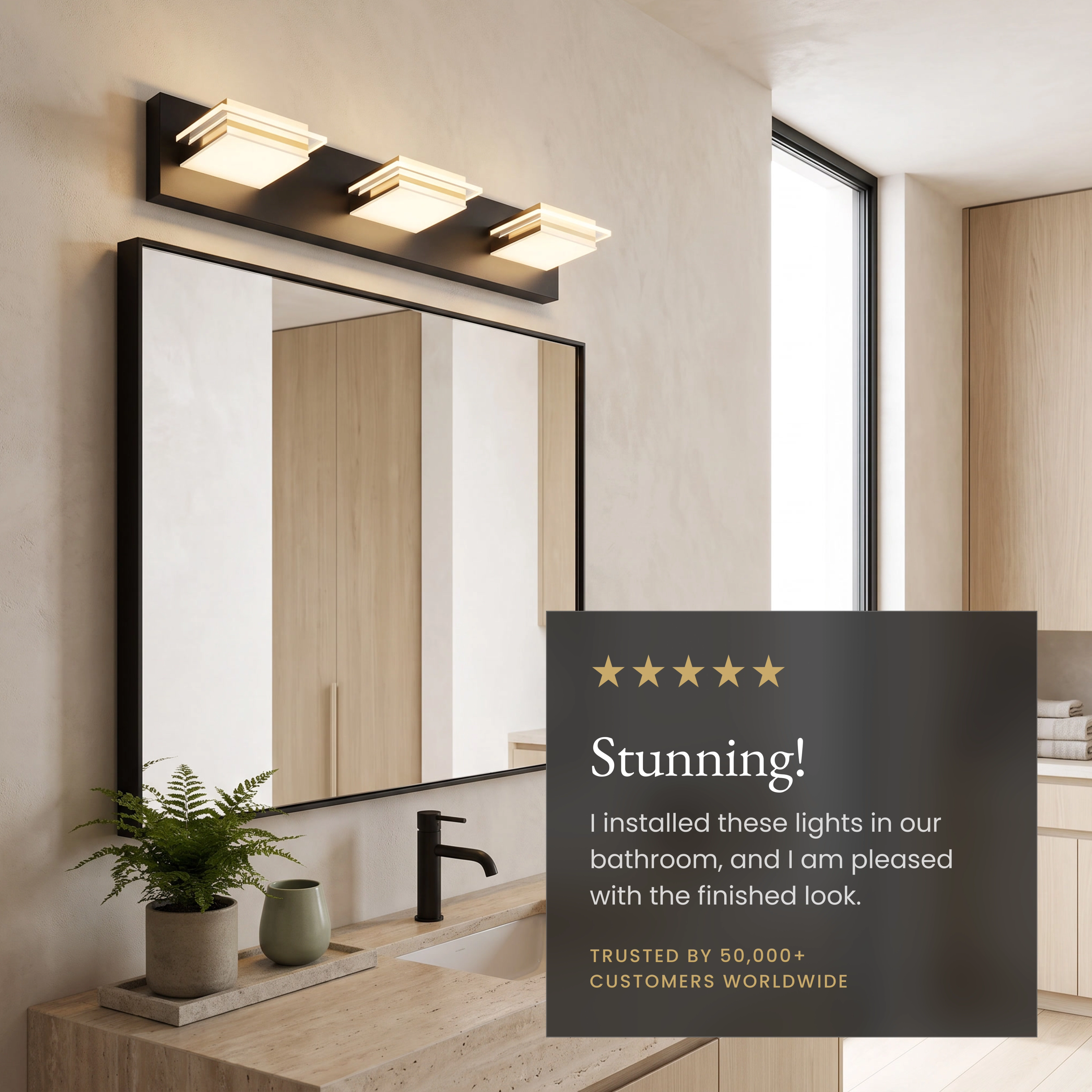 Willow three-light black-and-gold cube vanity light over a mirror, dimmer-compatible and moisture-proof