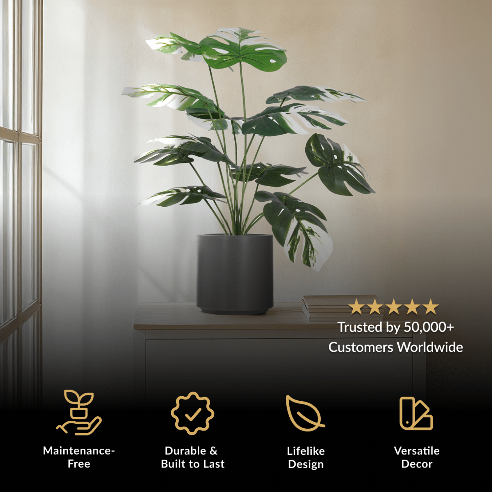 Monstera Albo, artificial plant with variegated green and white split leaves in a black pot