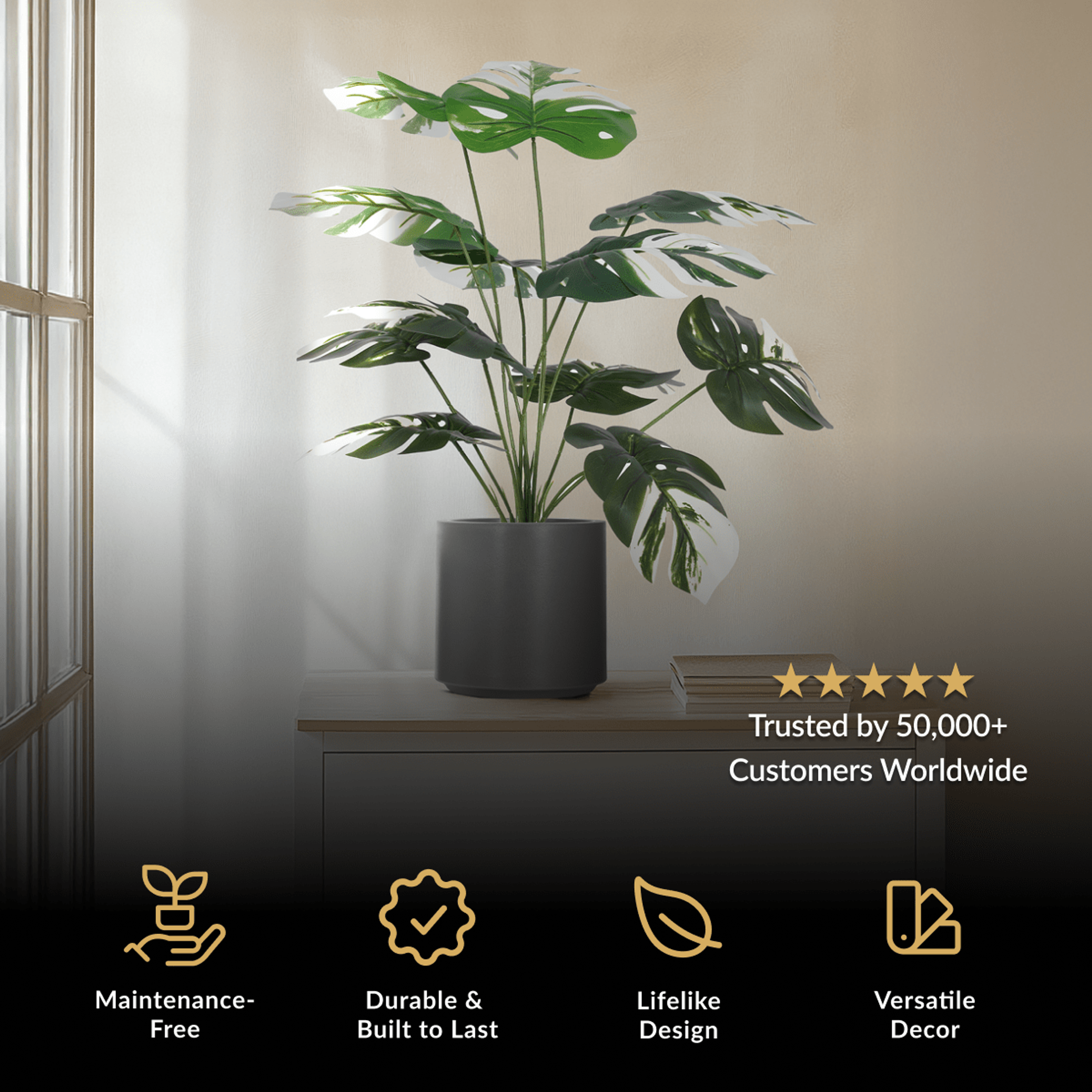 Monstera Albo, artificial plant with variegated green and white split leaves in a black pot