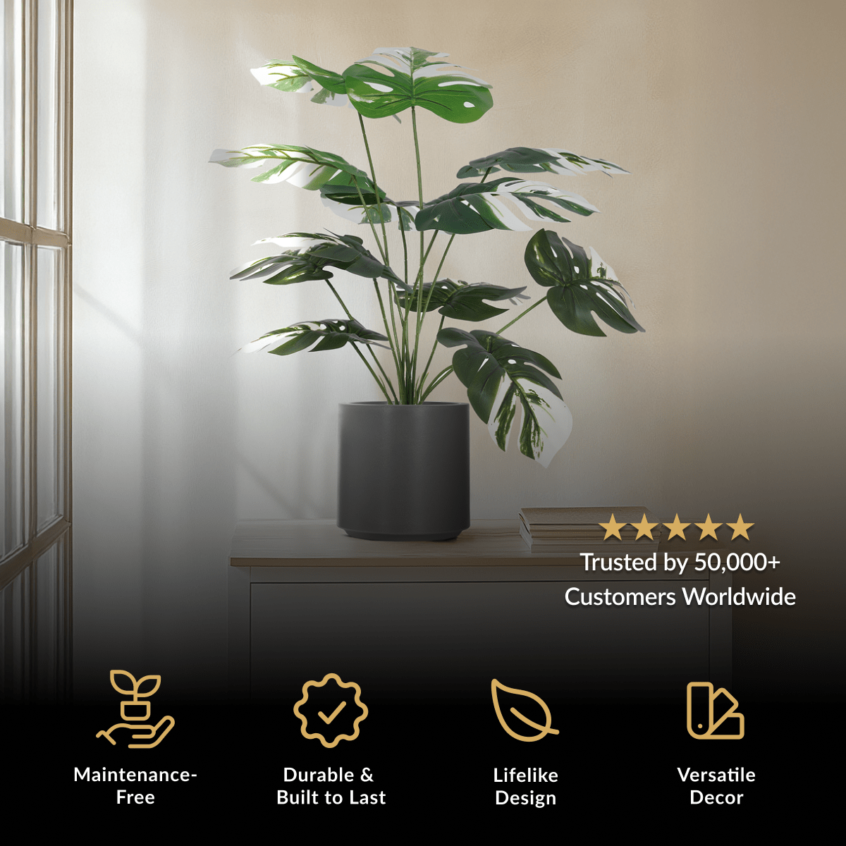 Monstera Albo, artificial plant with variegated green and white split leaves in a black pot
