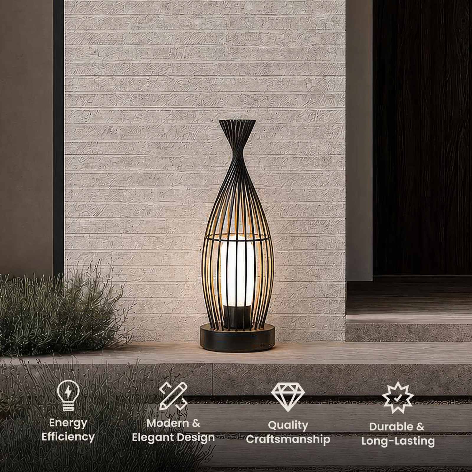 Cove black cage lantern with a pinched waist and opal glass core, on a stone step by a textured wall