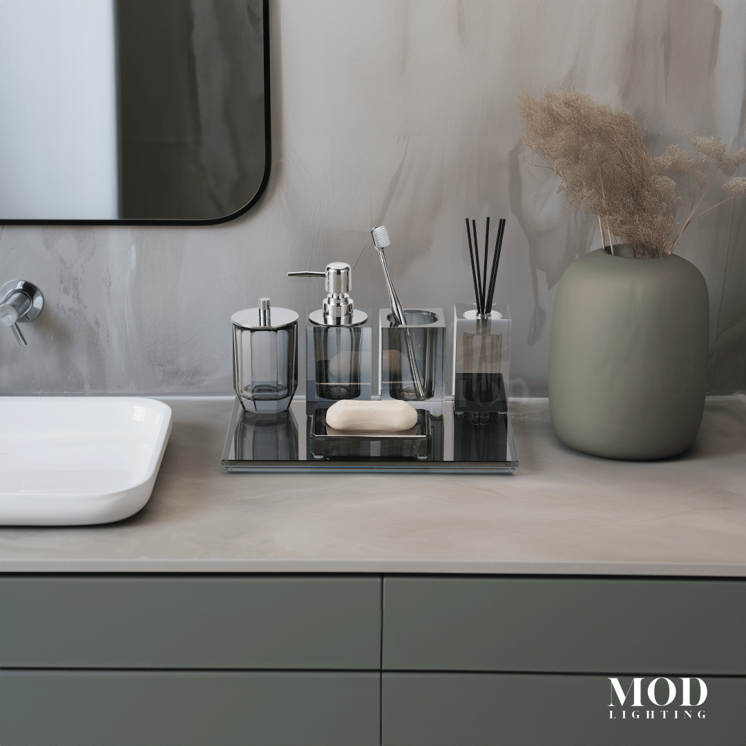 Moonlit Crystal Bath Set, smoky grey crystal accessories on a mirrored tray on a light stone vanity with a mirror