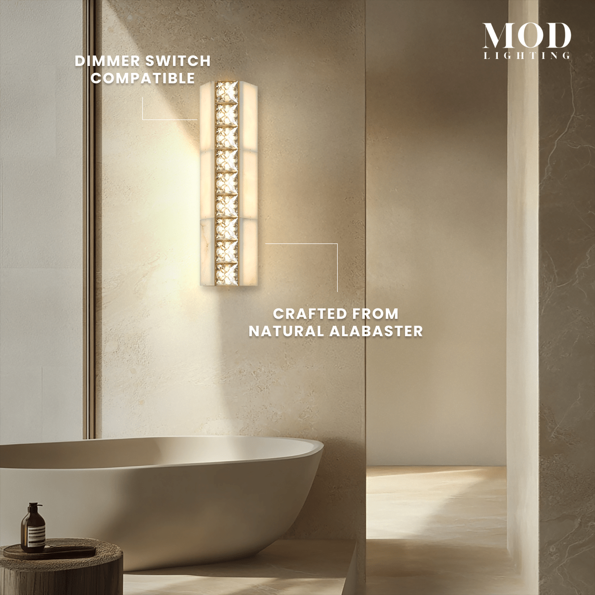 Seraphine Sconce gold alabaster wall light with crystal accents glowing on a wall above a bathtub