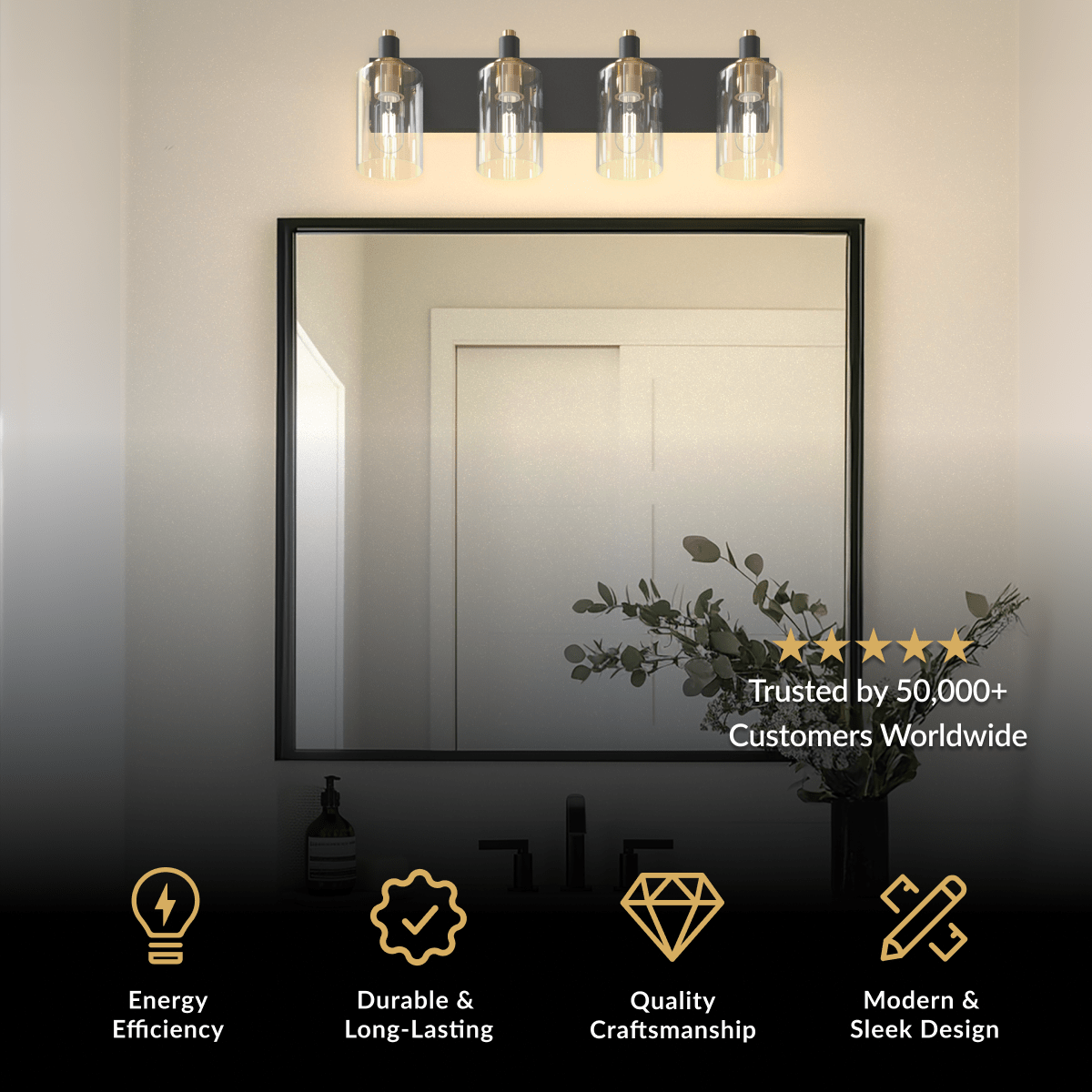 Hazel bathroom light, four clear glass shades on a matte black bar with gold accents above a black-framed mirror
