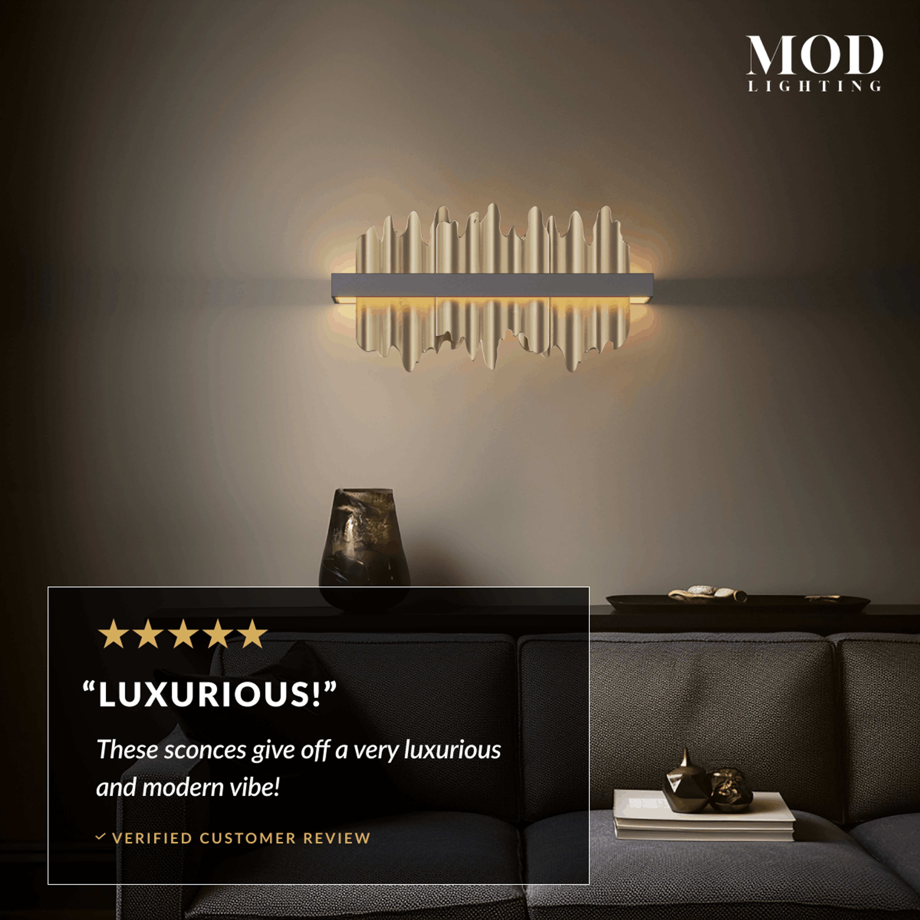 Aurelius wall sconce, gold bar with crystal spikes lit warm white on a dark wall