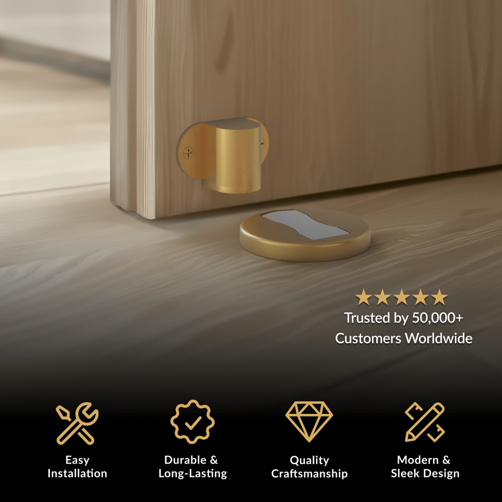 Moro Door Stop, brushed gold wall-mounted stop with a low floor plate beside a wood door