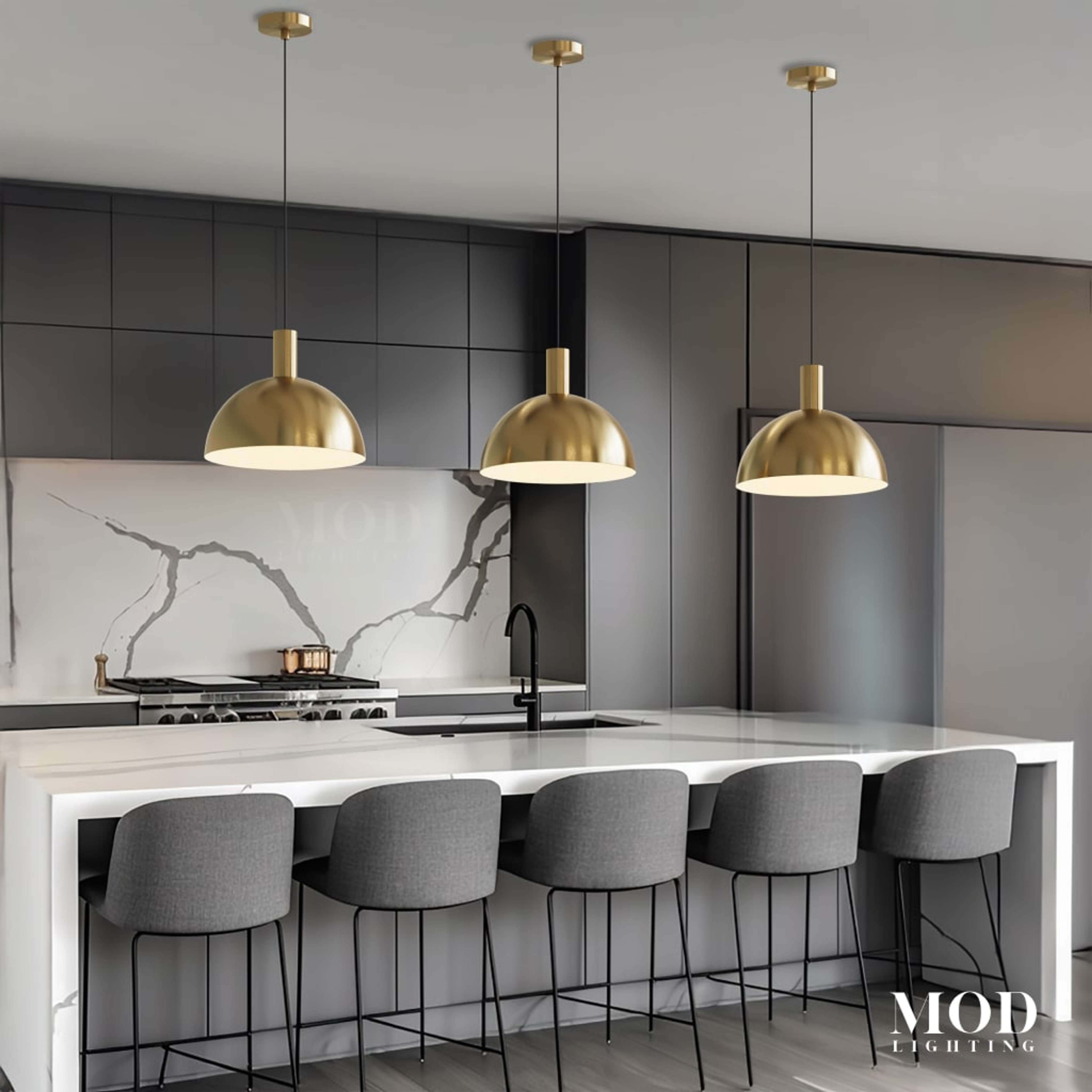 Kinsley brushed-gold dome pendants, three hanging over a marble kitchen island with grey bar stools