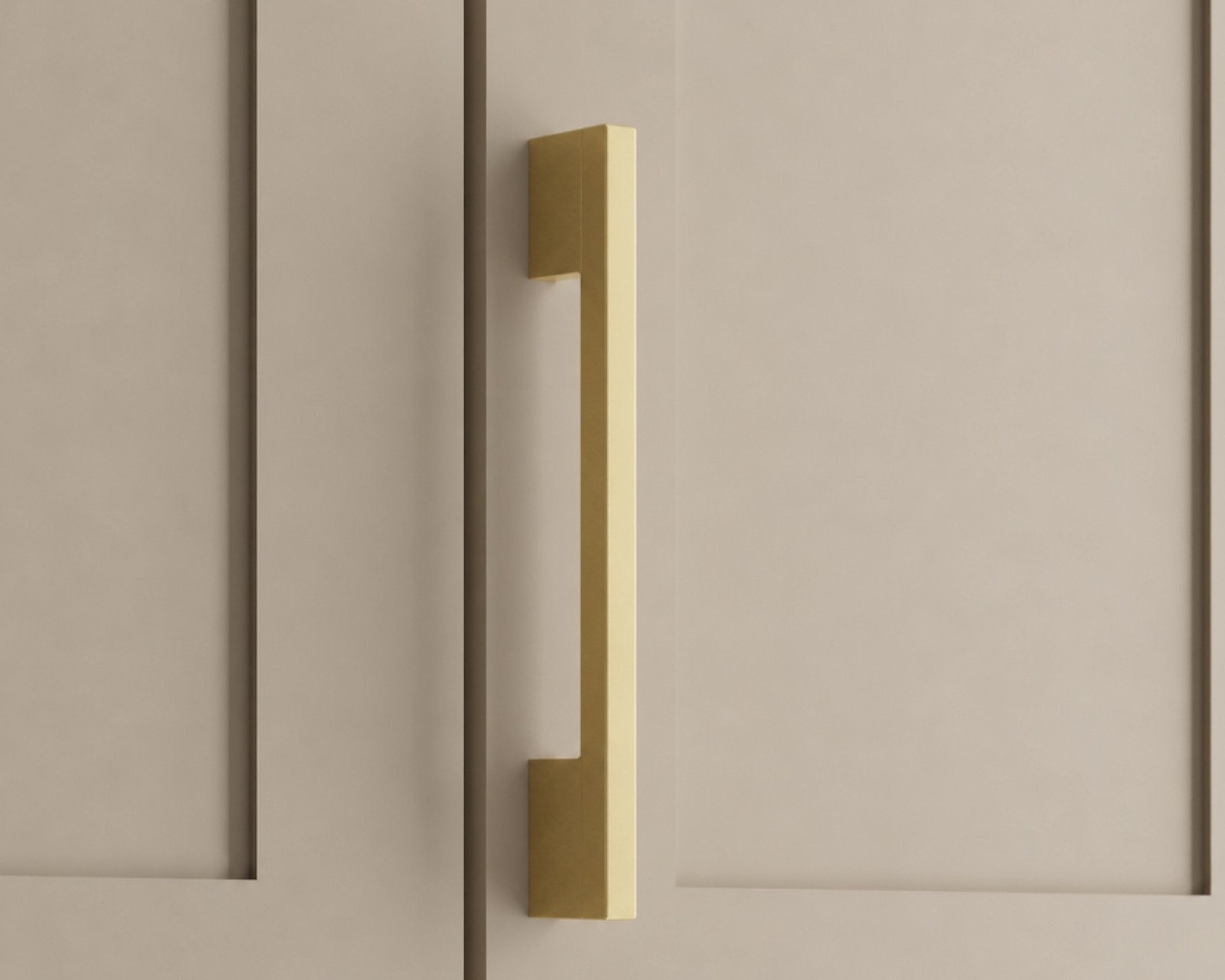 Maddison brass cabinet pull on a beige cabinet